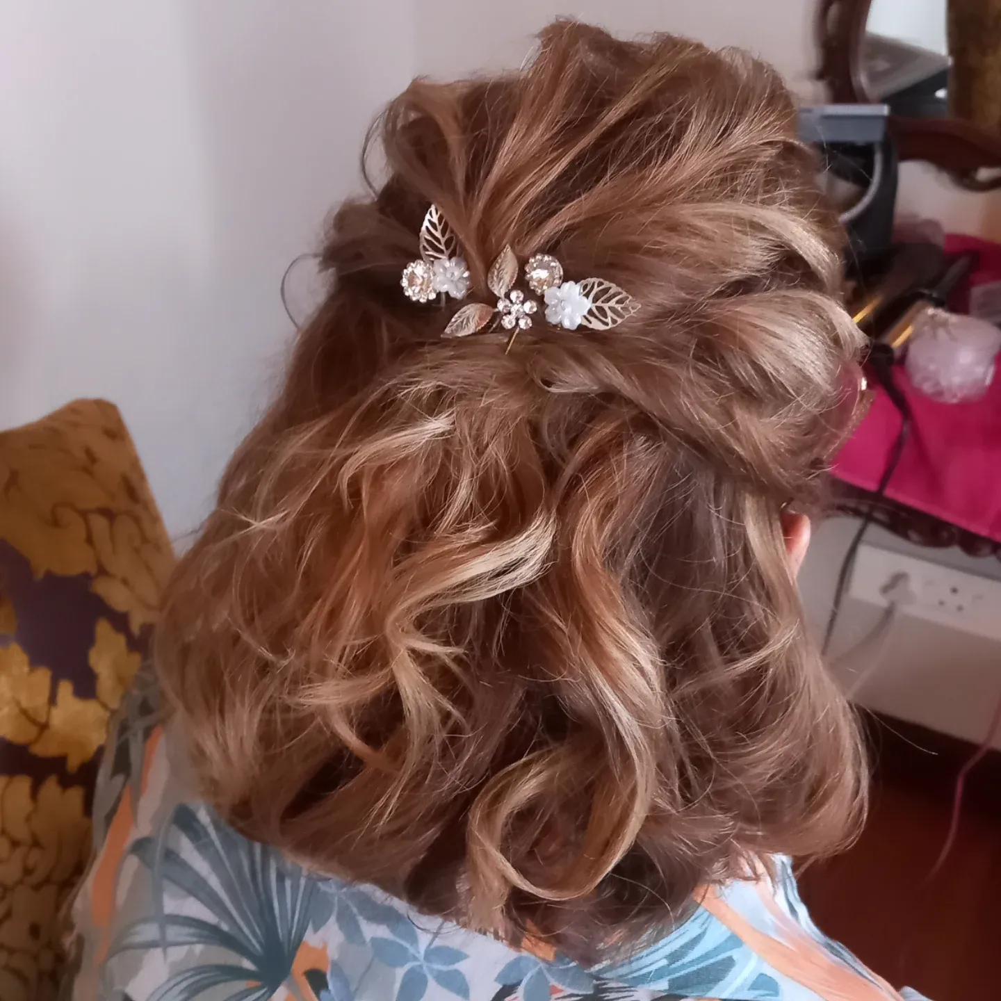 Voluminous half-up curls with delicate floral pins