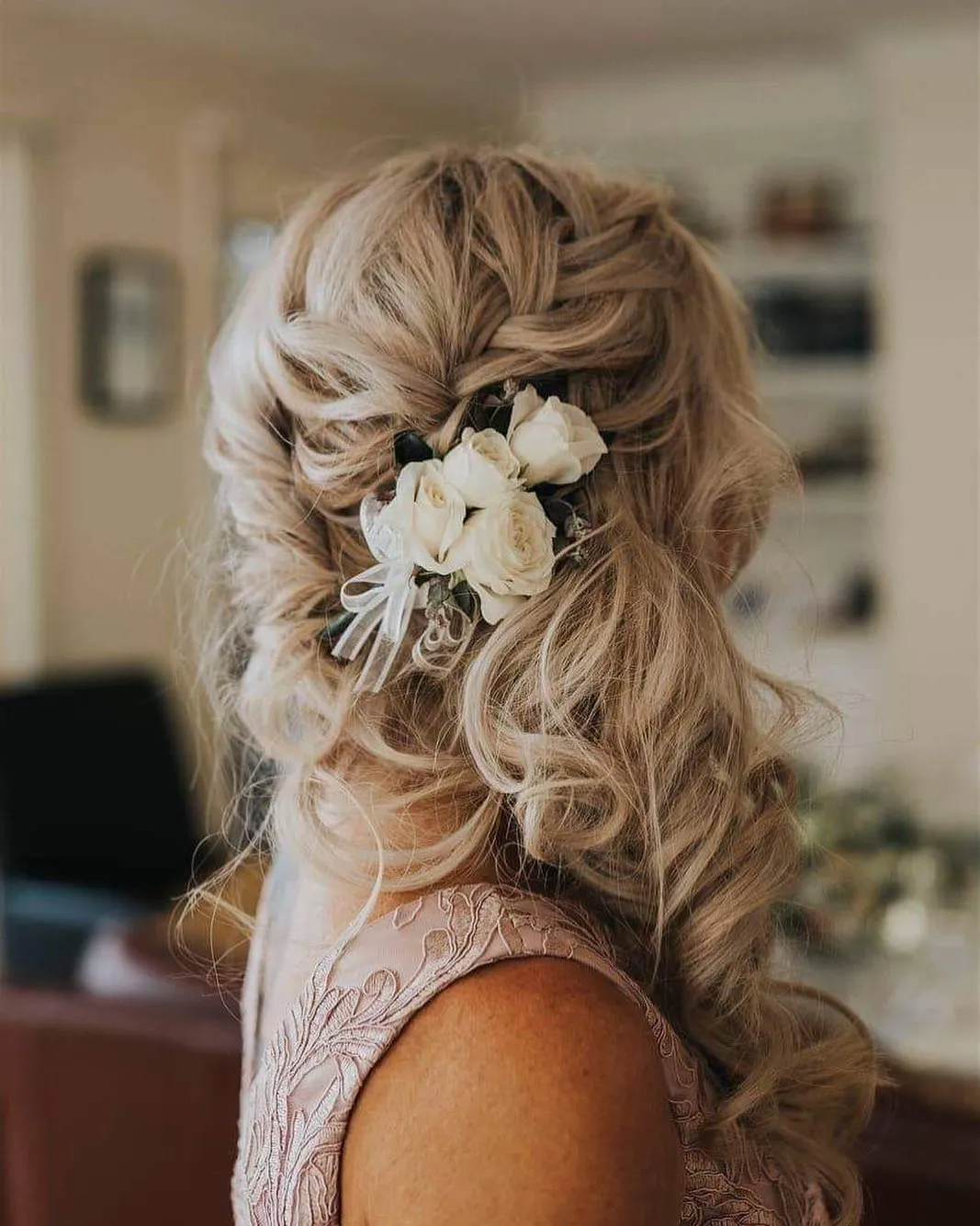 Long blonde side curls with white floral hair accessories