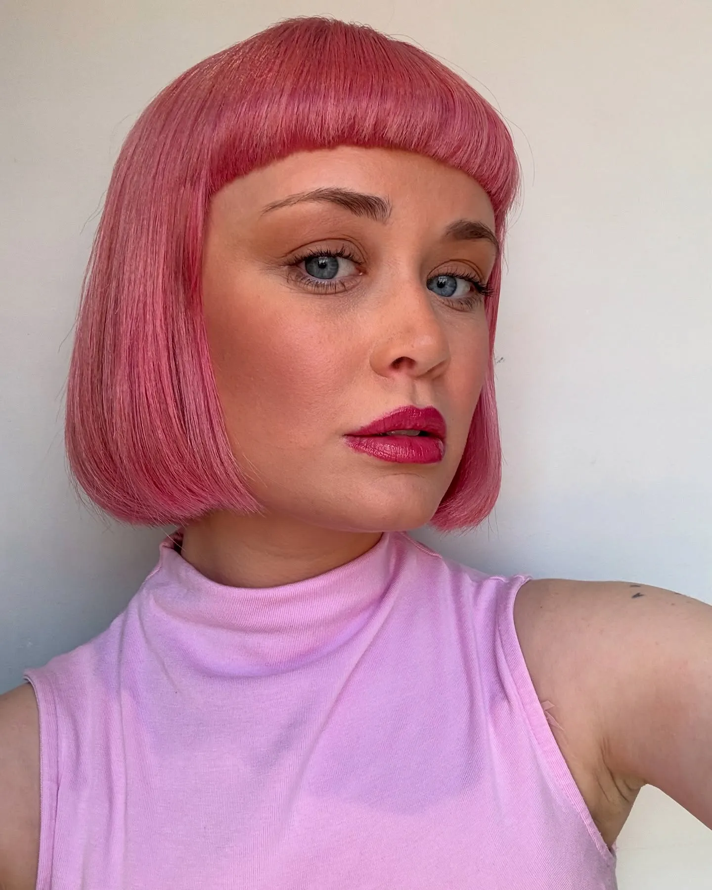 Straight pink blunt bob with short rounded fringe