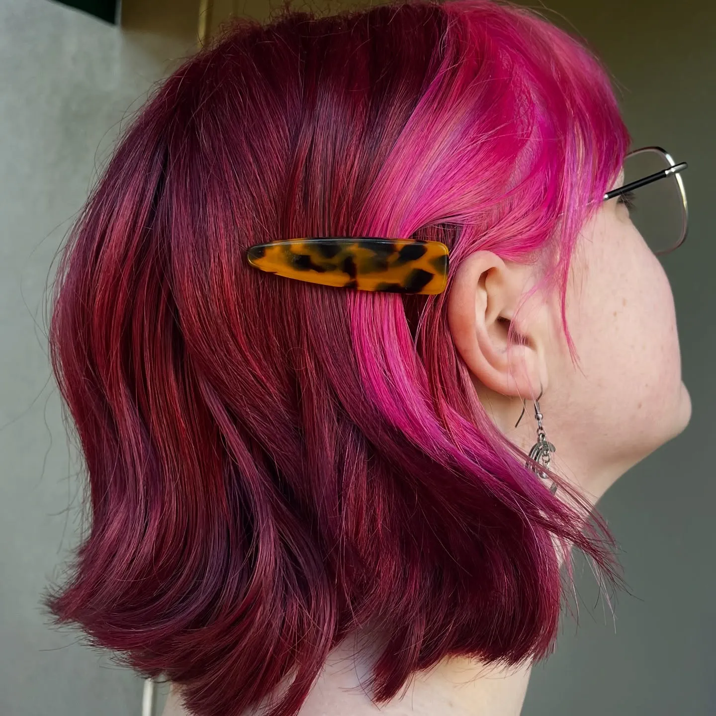 Deep magenta layered bob with side hair clip