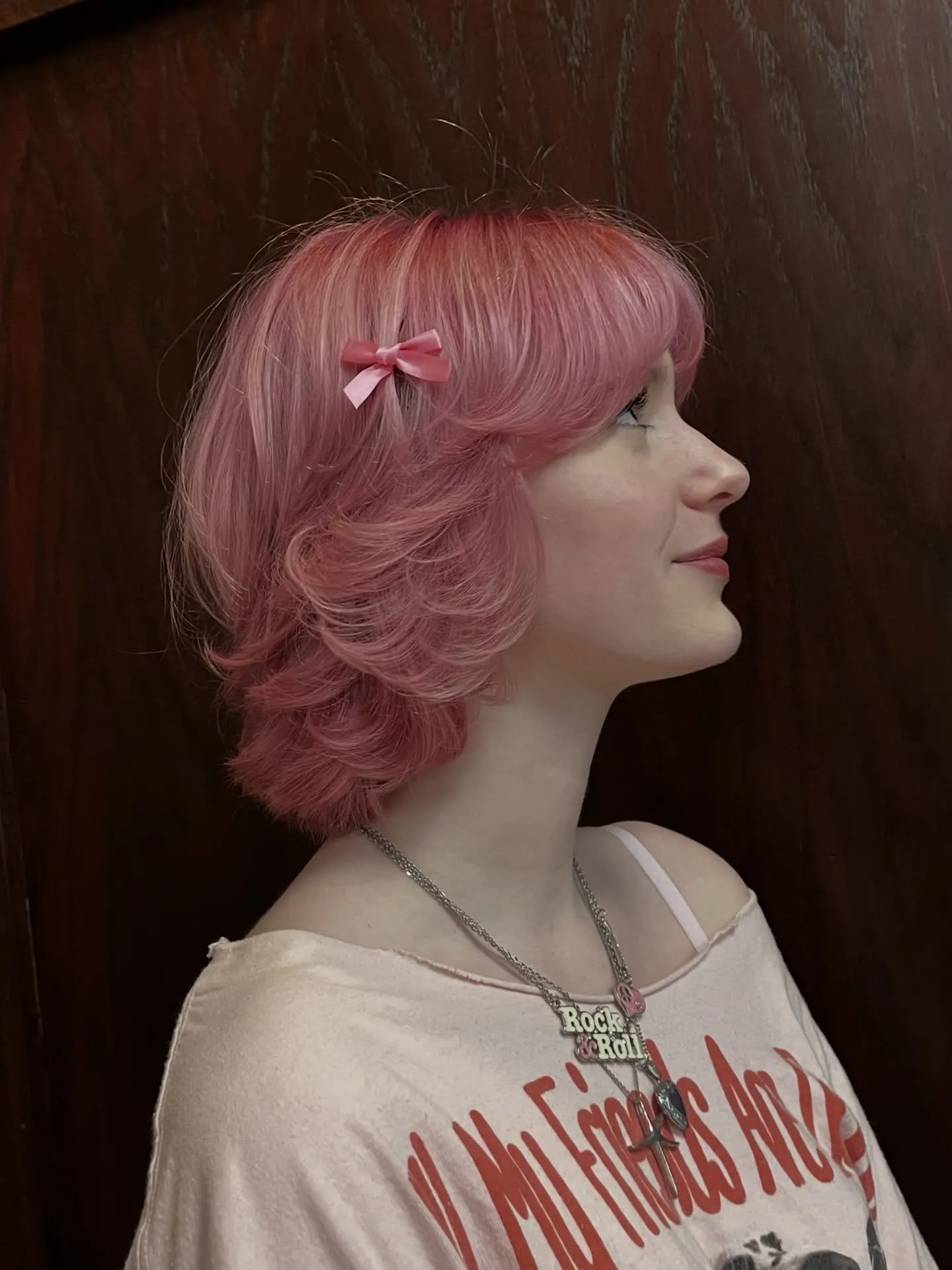 Soft pink layered bob with curled ends and side clip