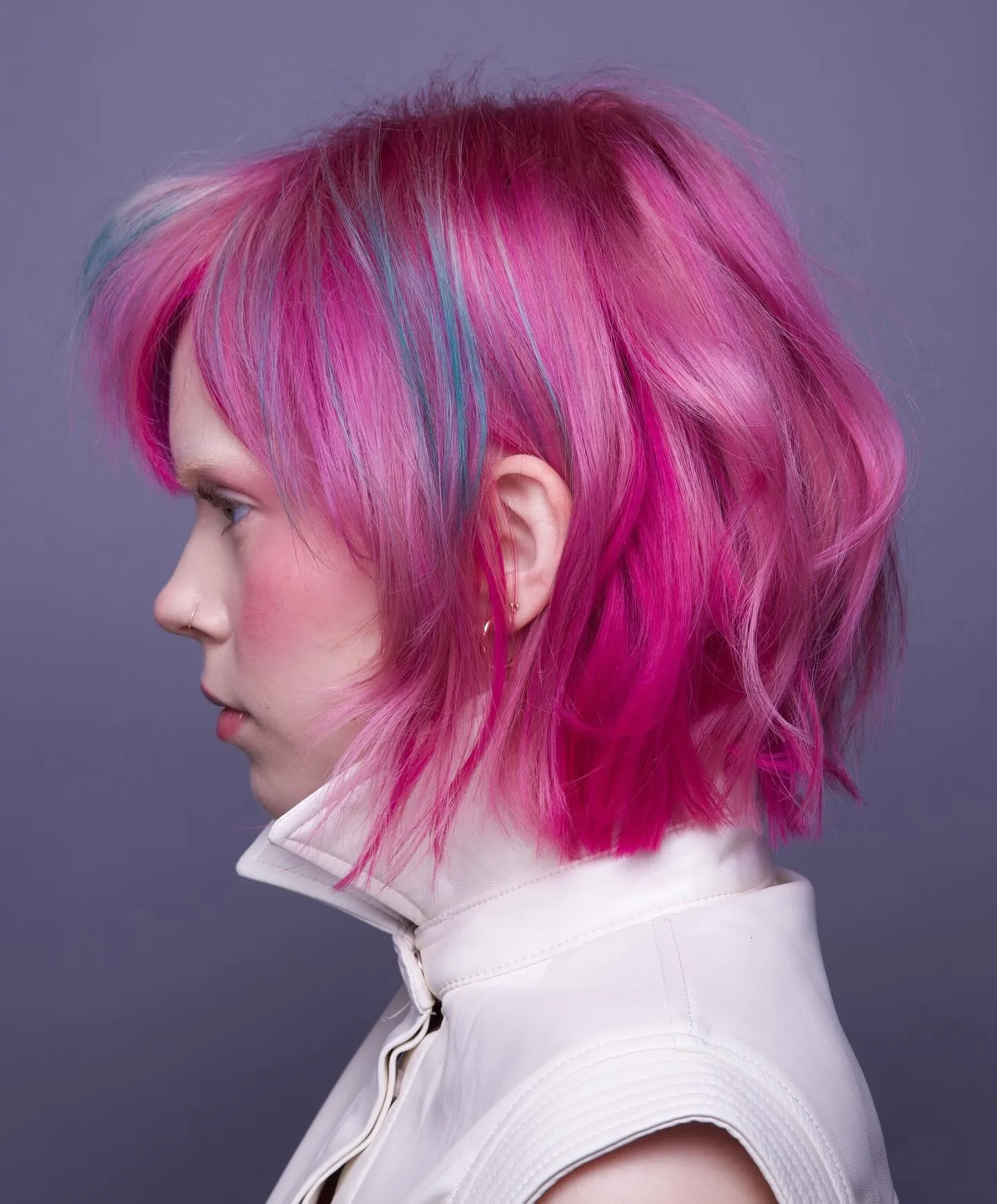 Textured vivid pink bob with cool-toned streaks