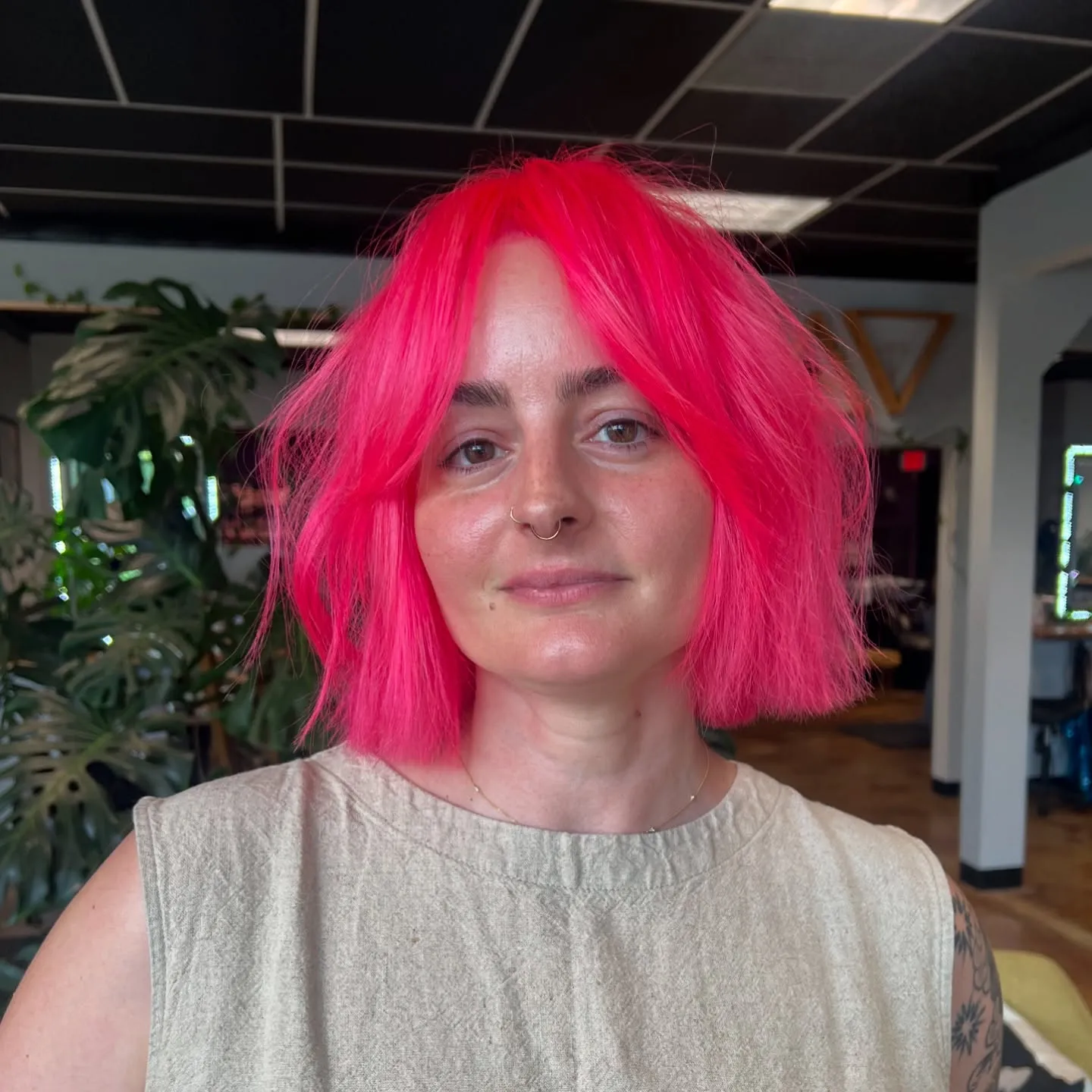Neon pink blunt bob with centre-parted fringe