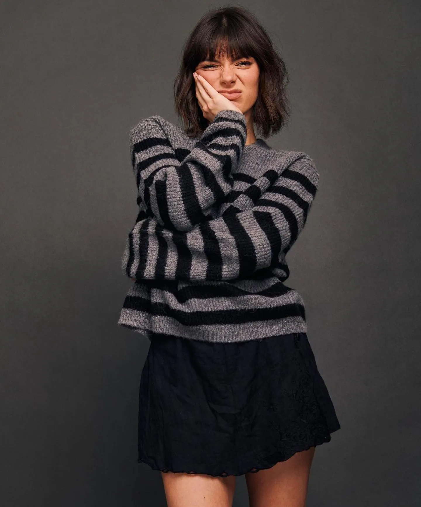 Dark razor cut bob with full fringe and textured shoulder-skimming ends