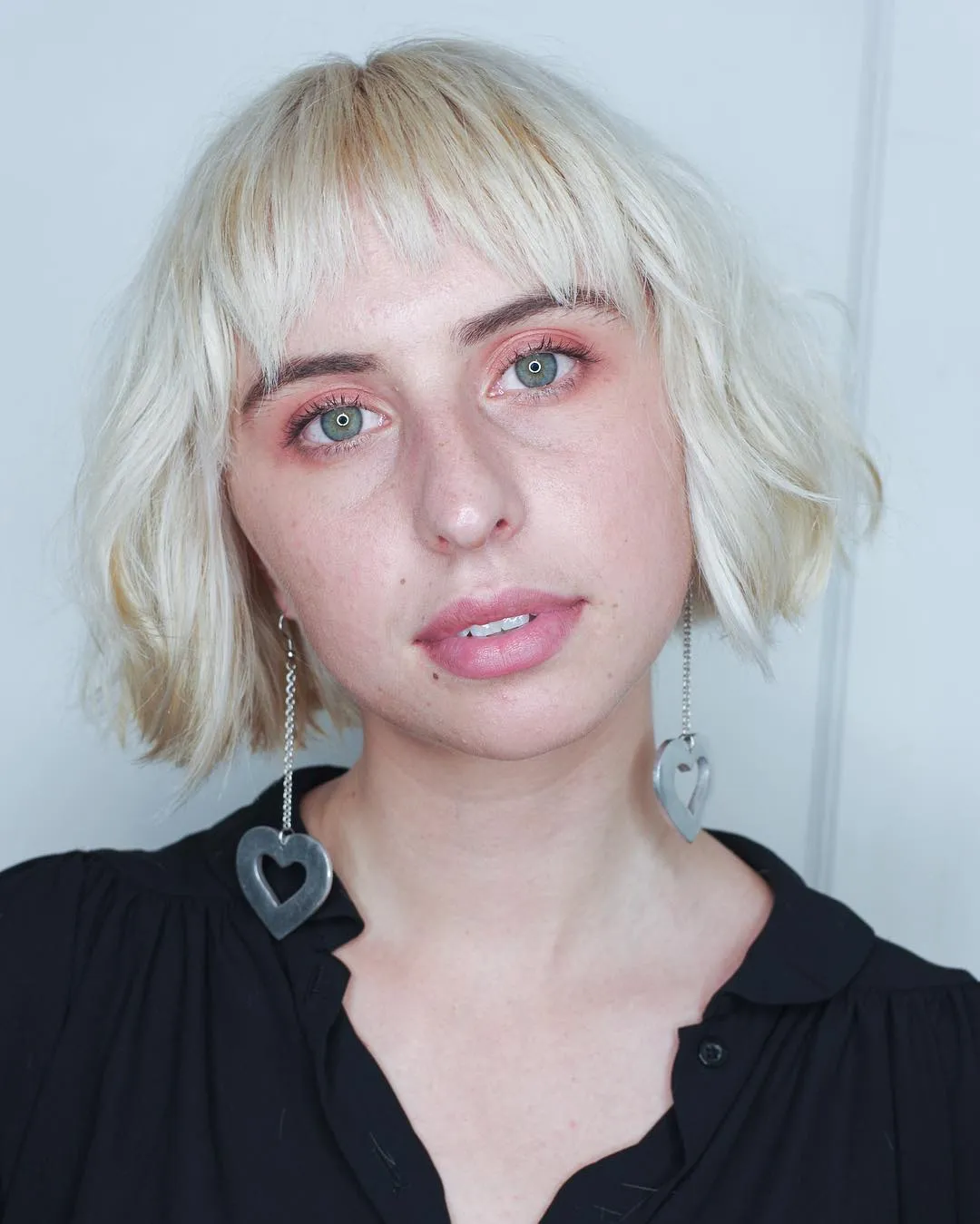 Light blonde razor cut bob with wispy fringe and uneven textured ends