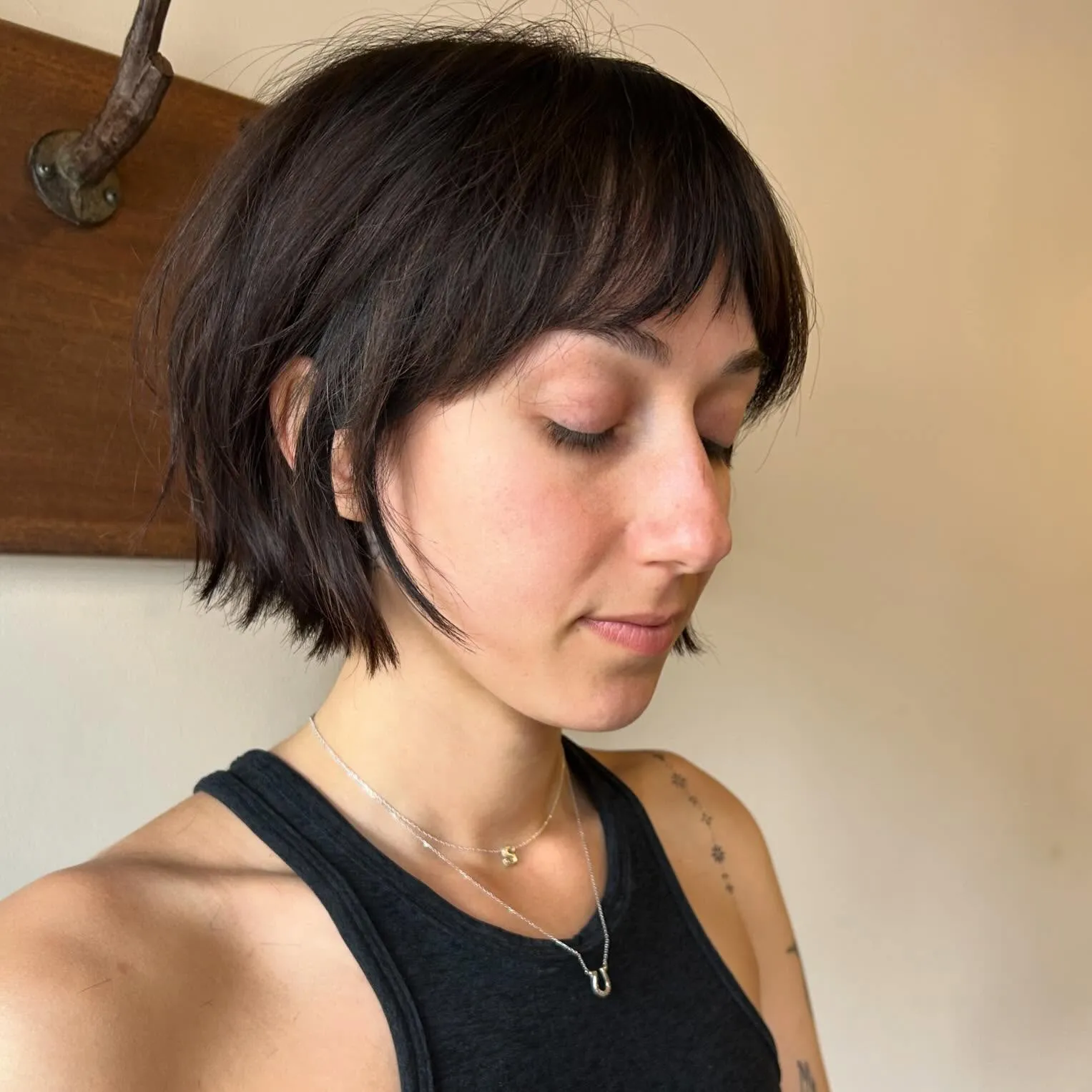 Short dark razor cut bob with tapered sides and rounded fringe
