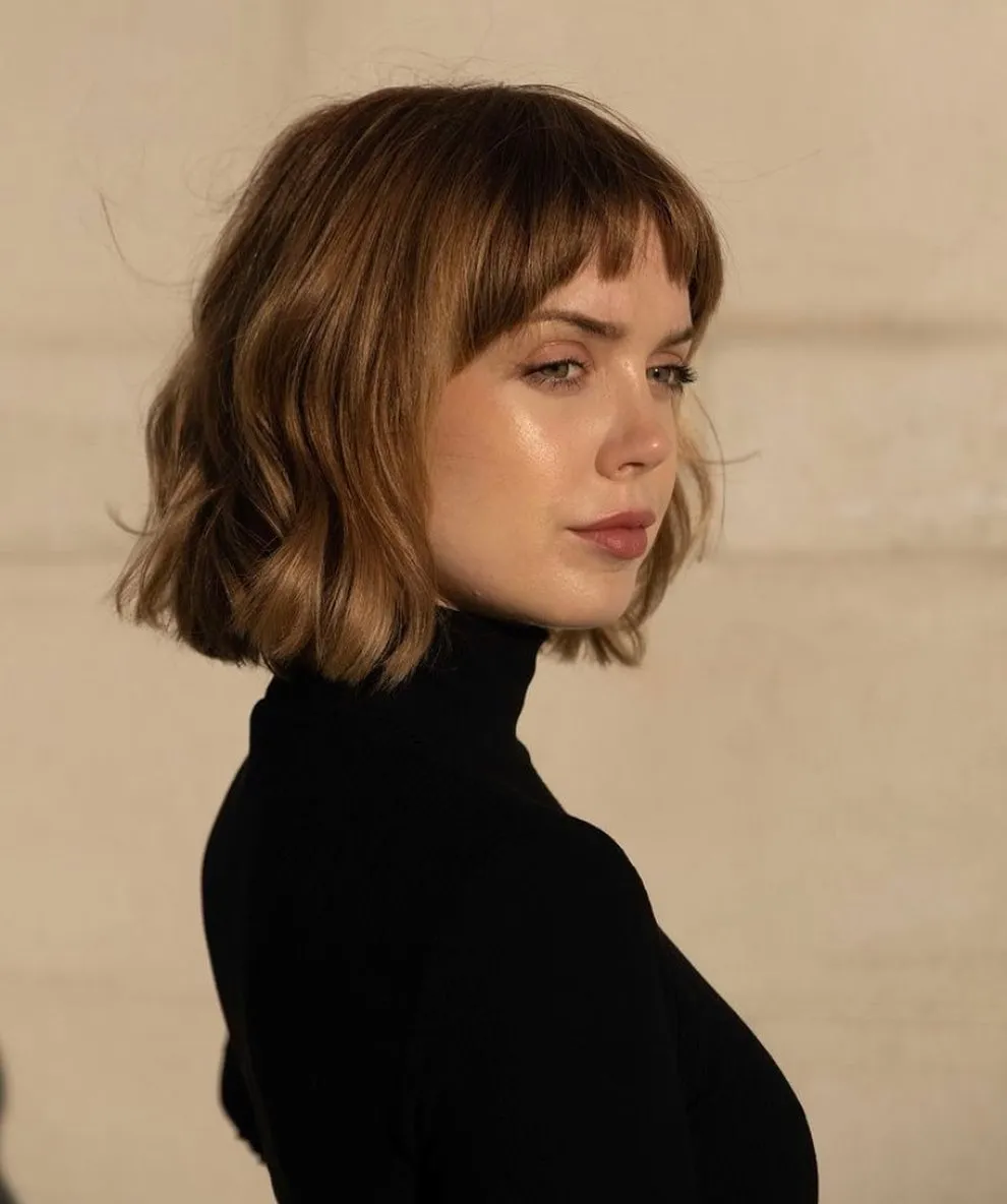 Short copper razor cut bob with soft waves and short fringe