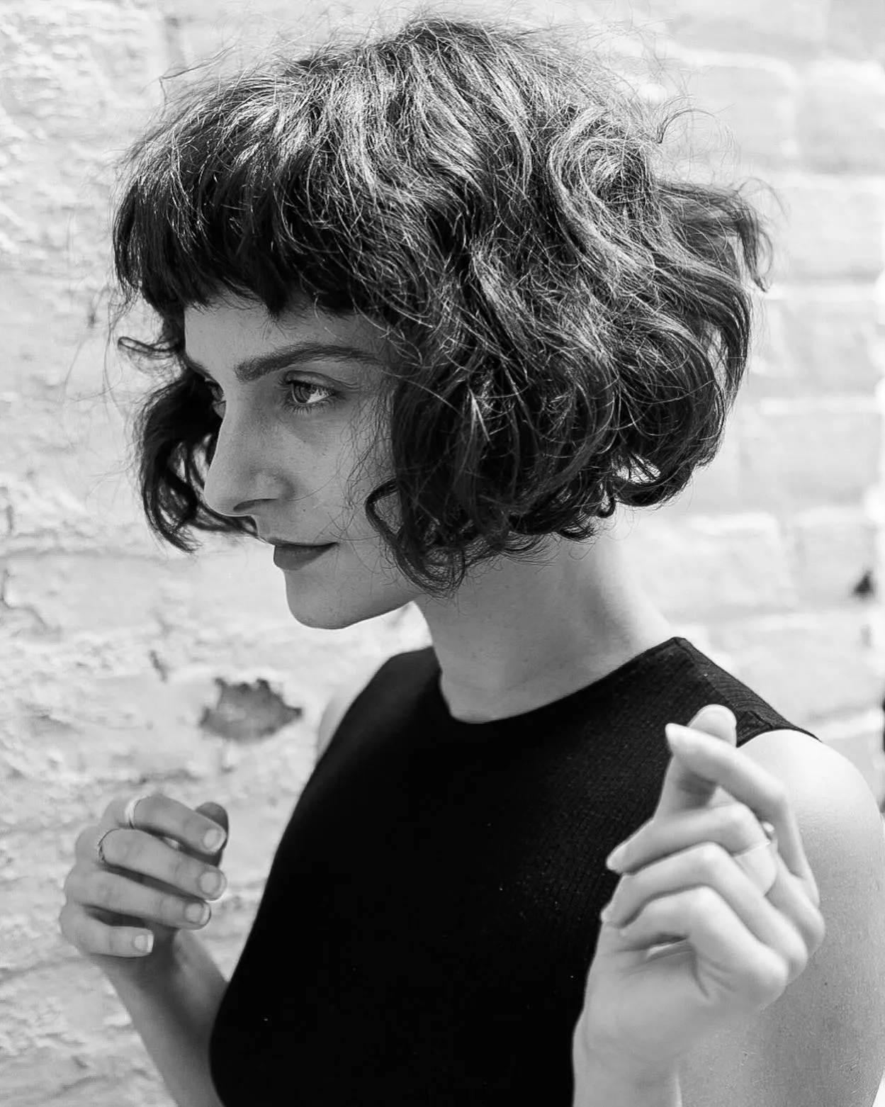 Short curly razor cut bob with rounded volume and short fringe