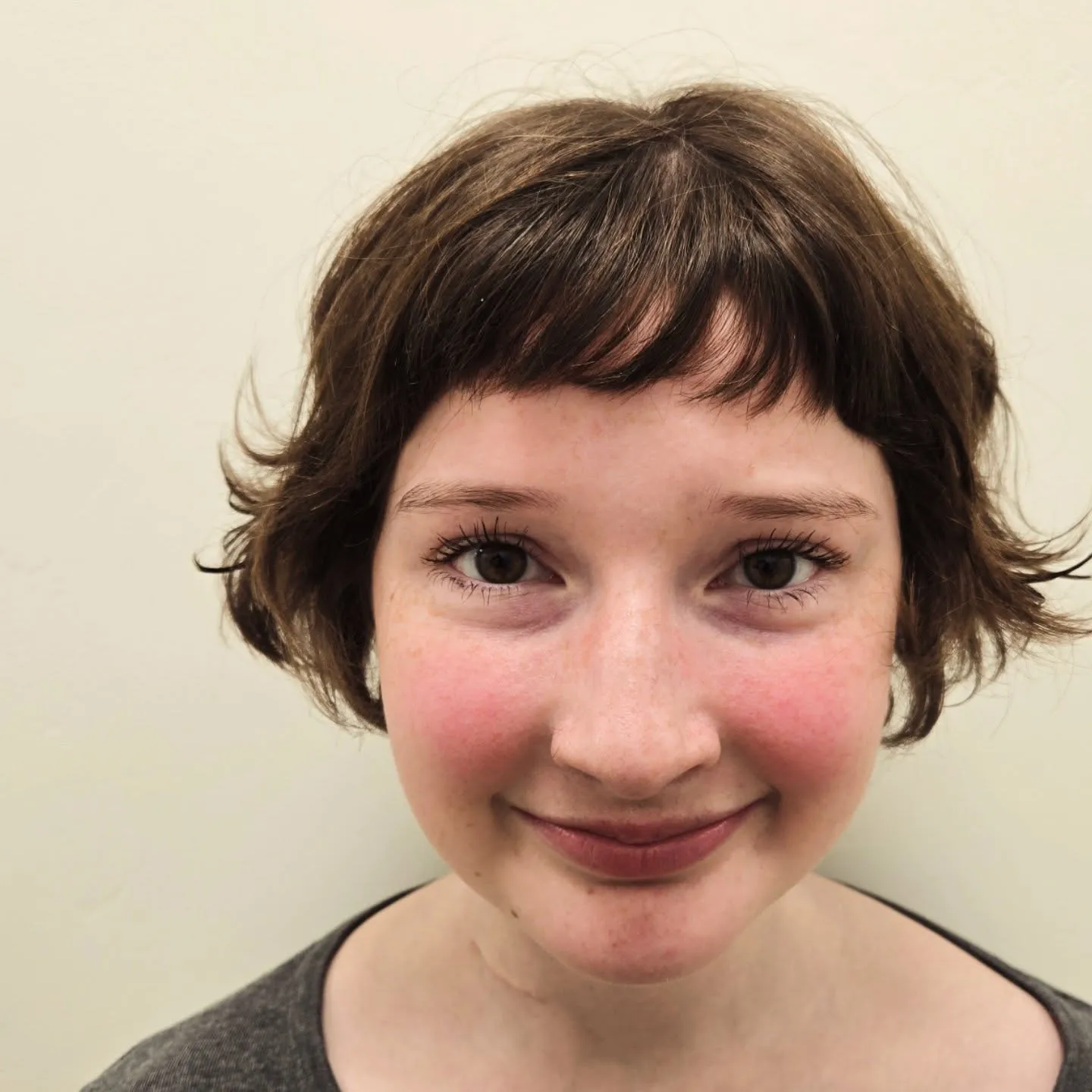 Very short razor cut bob with baby bangs and flipped side ends