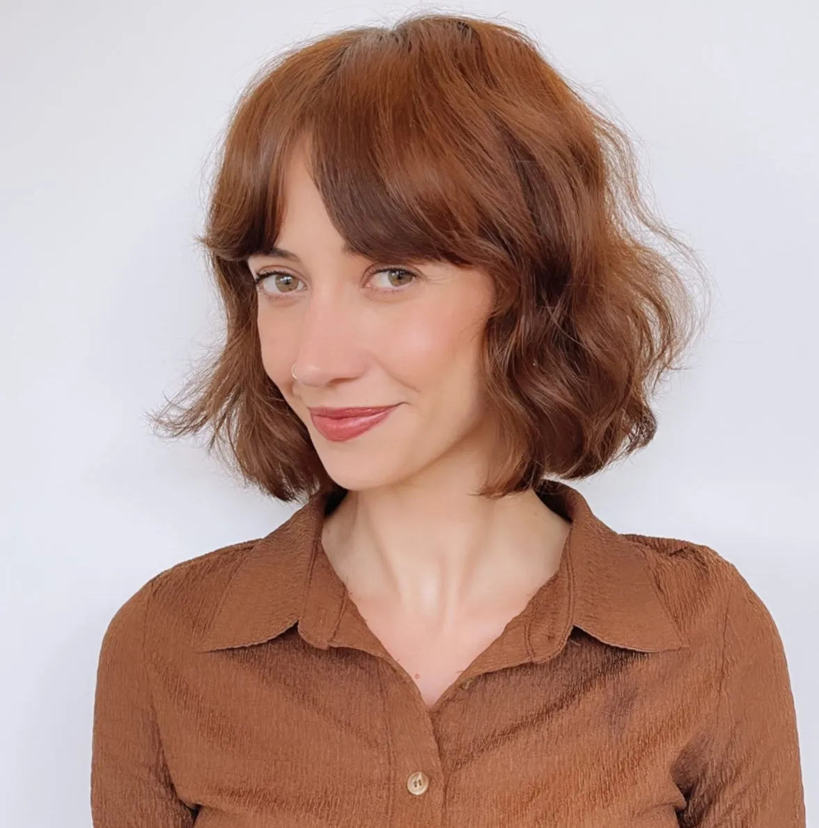 Copper brown razor cut bob with soft waves and curtain fringe