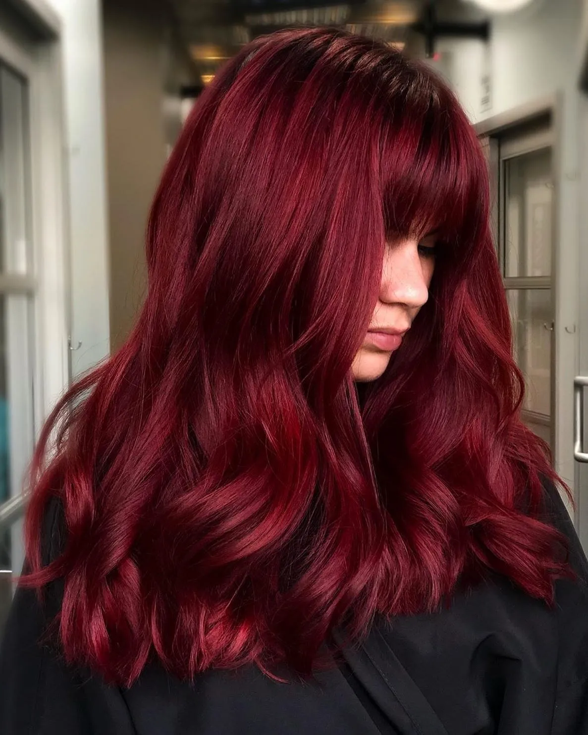 Long deep red waves with a full sweeping fringe
