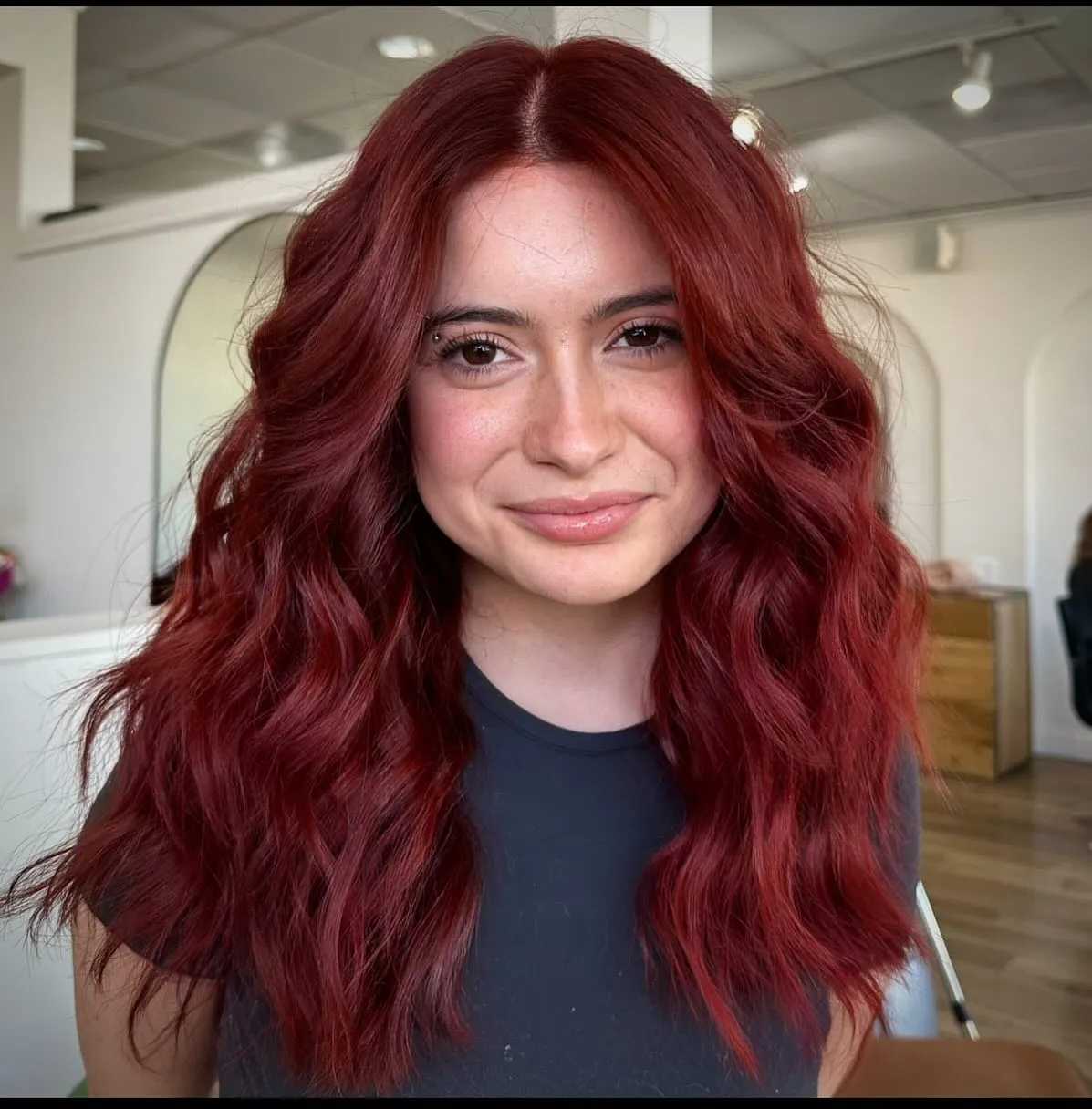 Long warm red waves with a centre part and soft face framing
