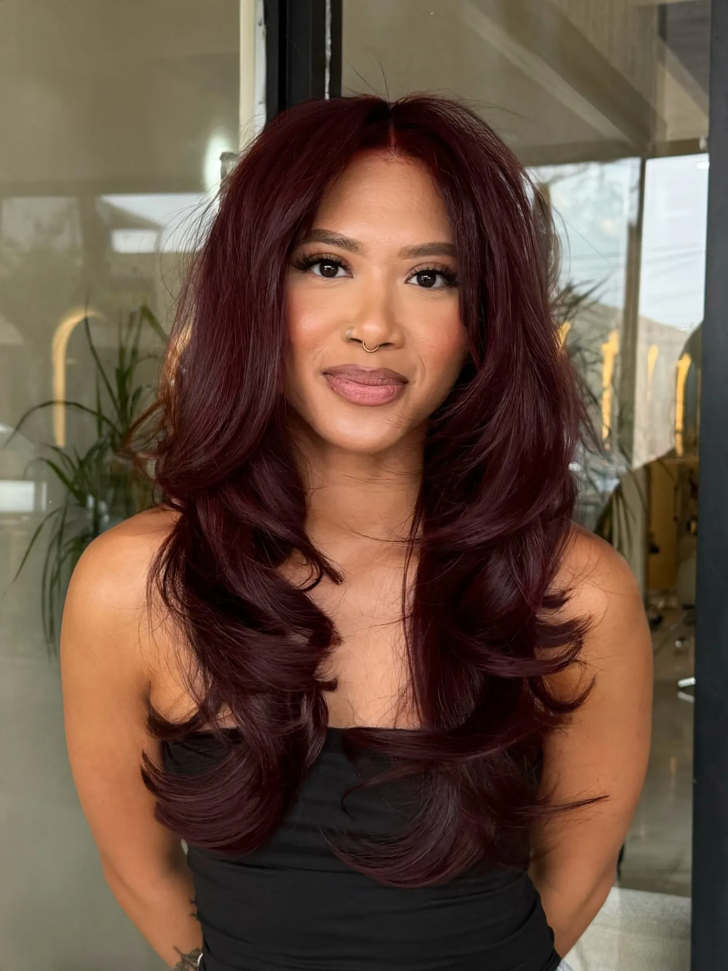 Long polished layers with deep dark red hair color