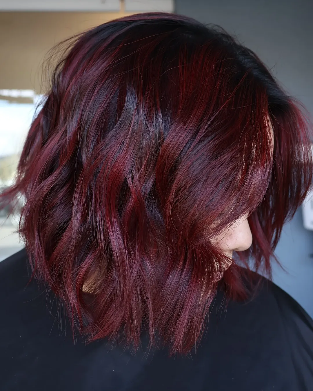 Short textured bob with dark red and burgundy tones
