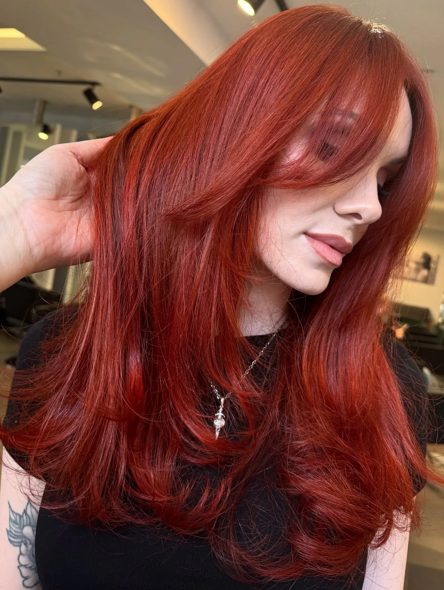Long bright copper-red hair with layered ends and side fringe