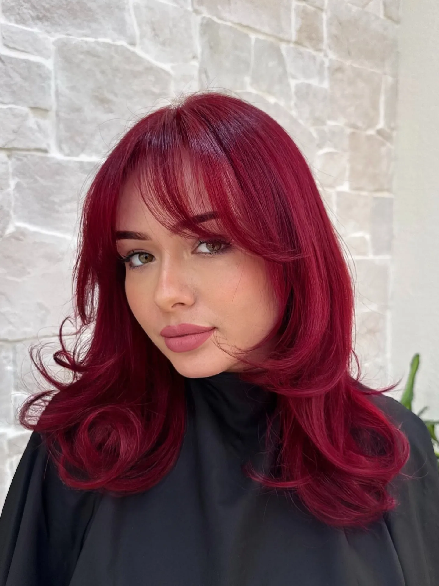 Medium magenta-red layered haircut with full wispy fringe