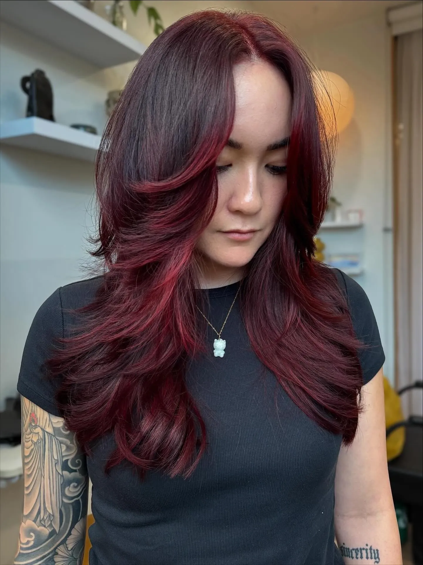 Long deep crimson hair with curtain fringe and feathered layers