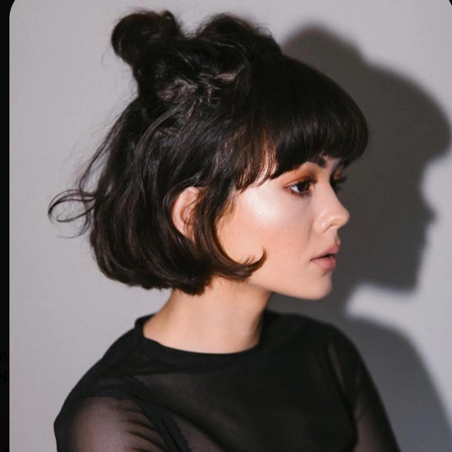Rounded bob with short fringe and half-up twist