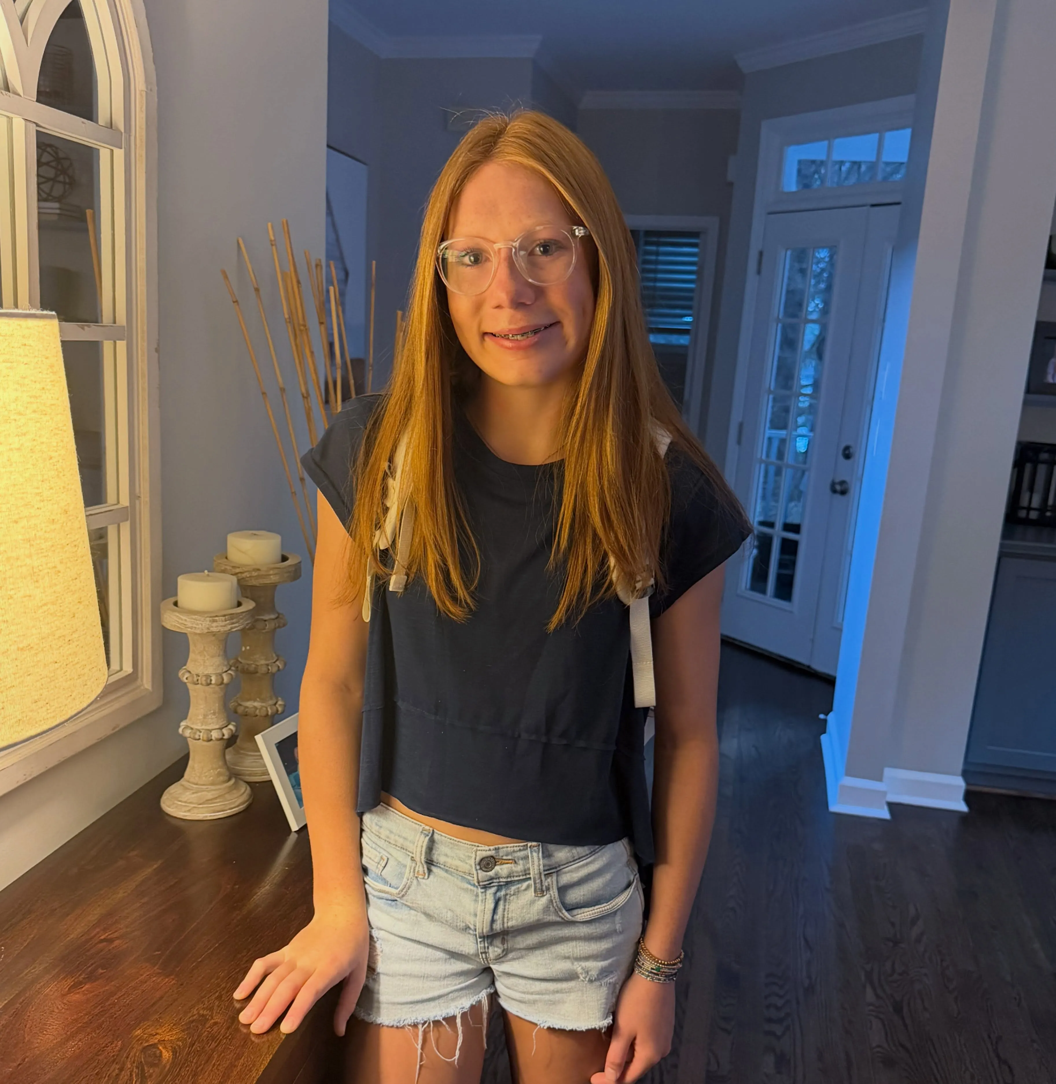 Straight medium-length hair with a center part