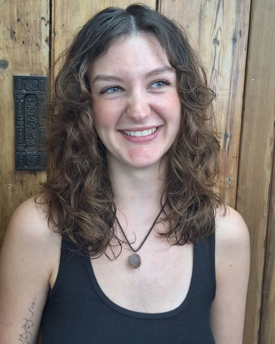 Natural curly shag with centre part and shoulder-length layers
