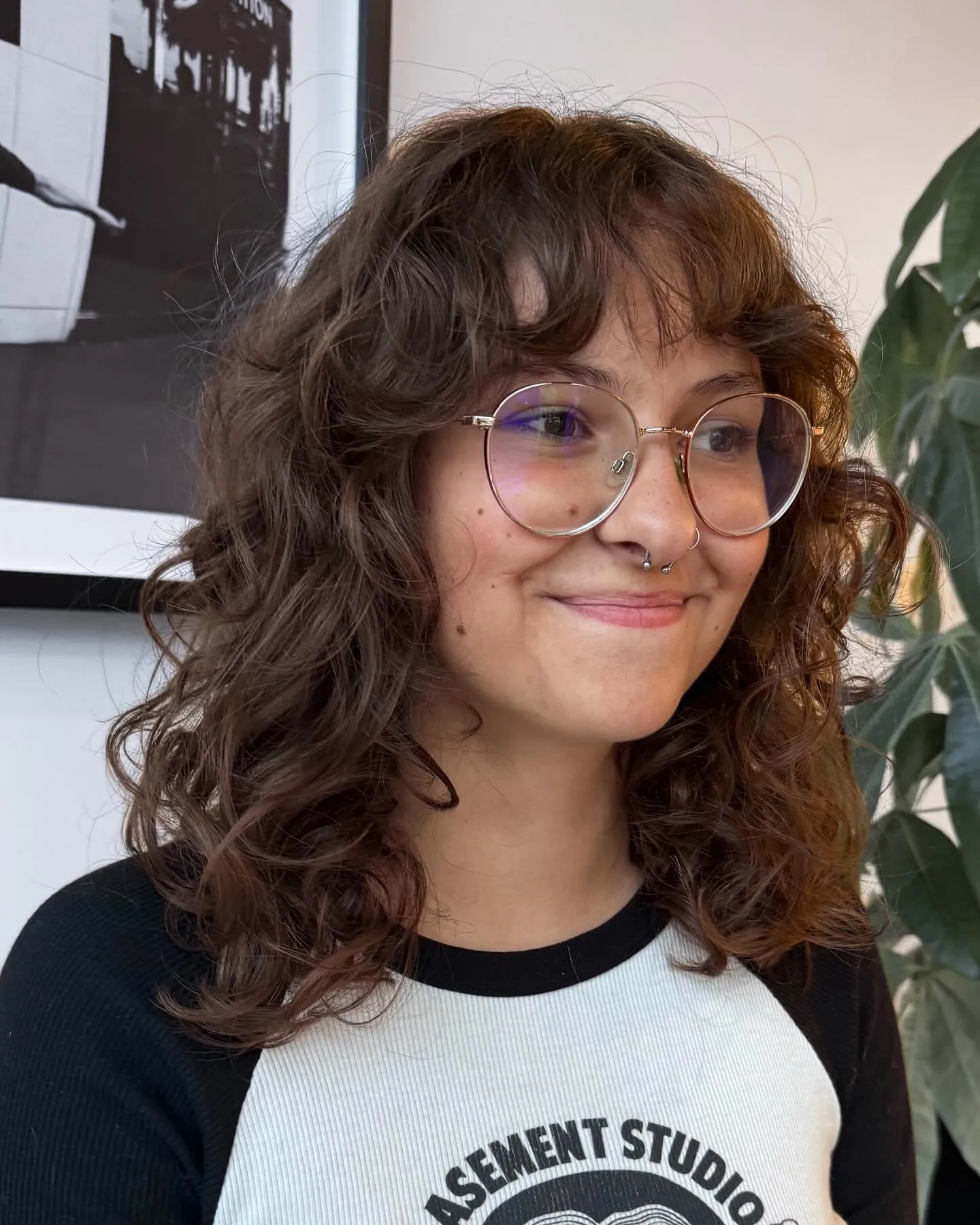 Curly shag bob with rounded fringe and defined shoulder-length curls