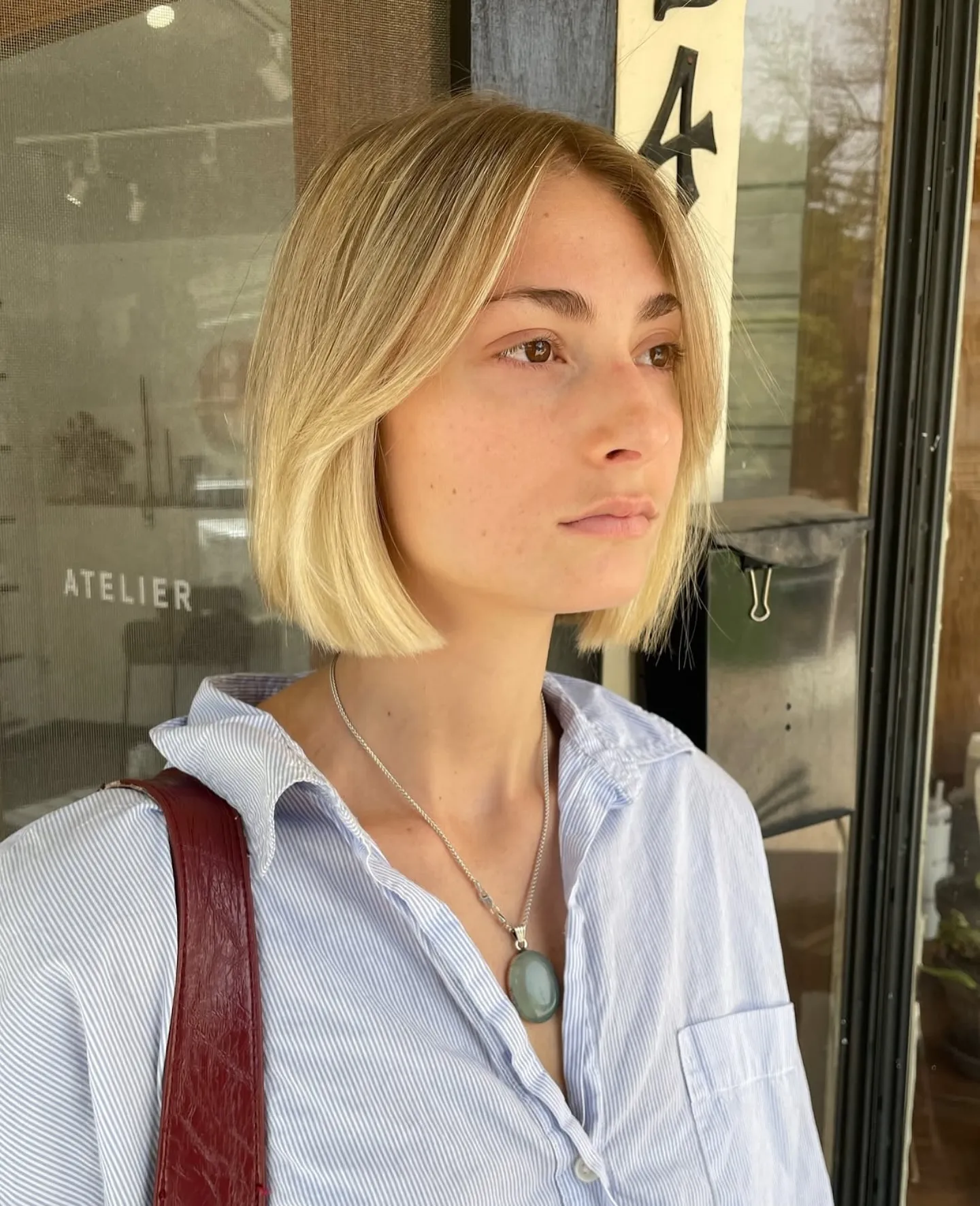 Sleek blunt chin-length bob with long curtain bangs and tucked sides