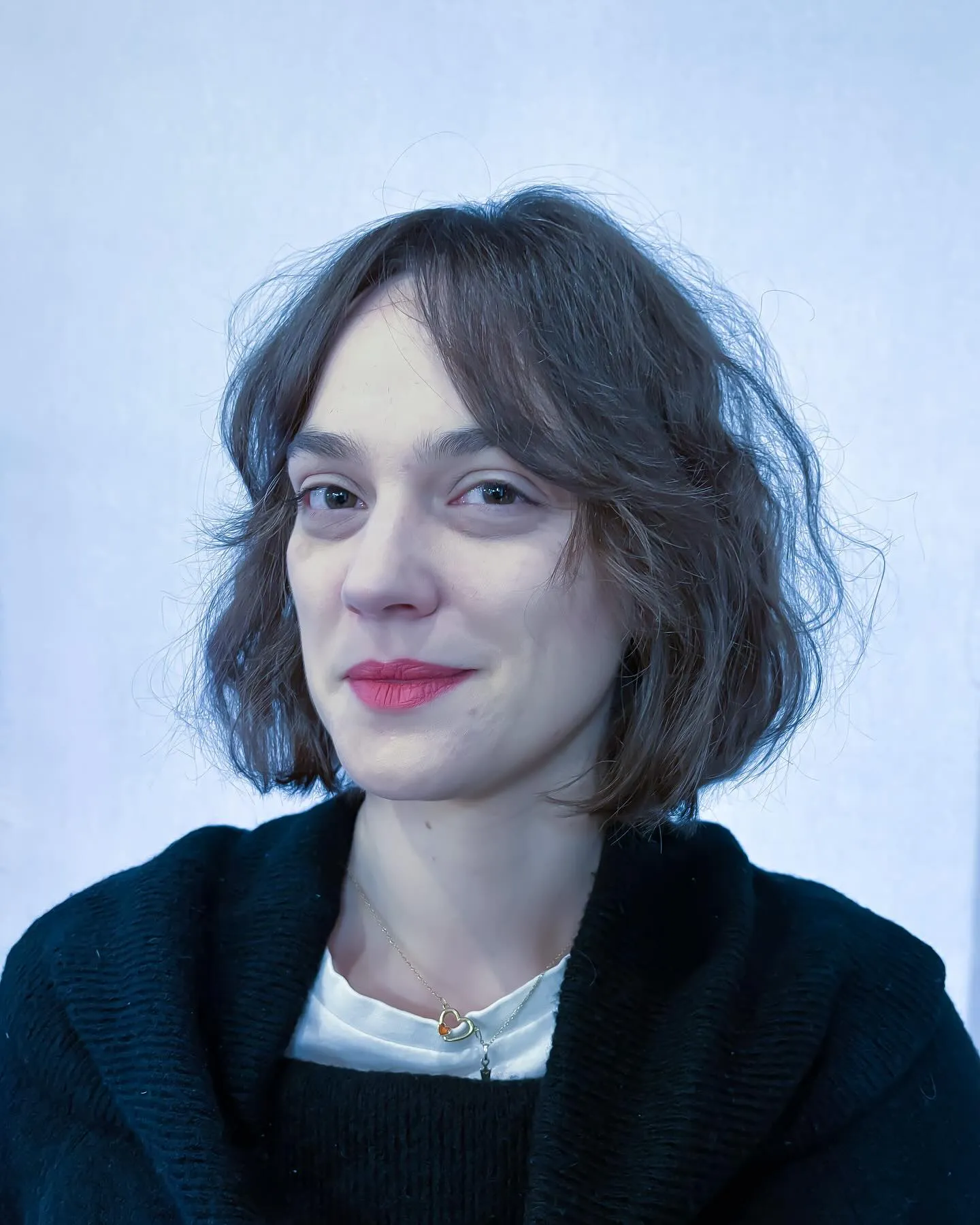 Loose wavy short bob with airy curtain bangs and soft chin-length texture