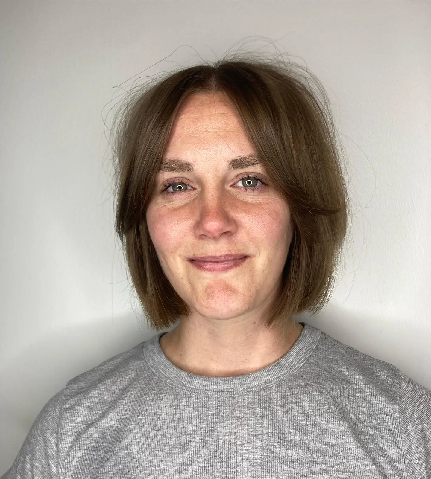 Straight rounded short bob with subtle curtain bangs and softly tapered ends