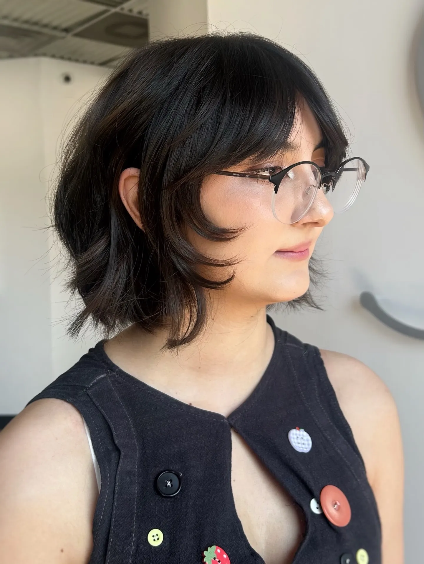 Flipped short bob with long curtain bangs and outward-curved face-framing layers