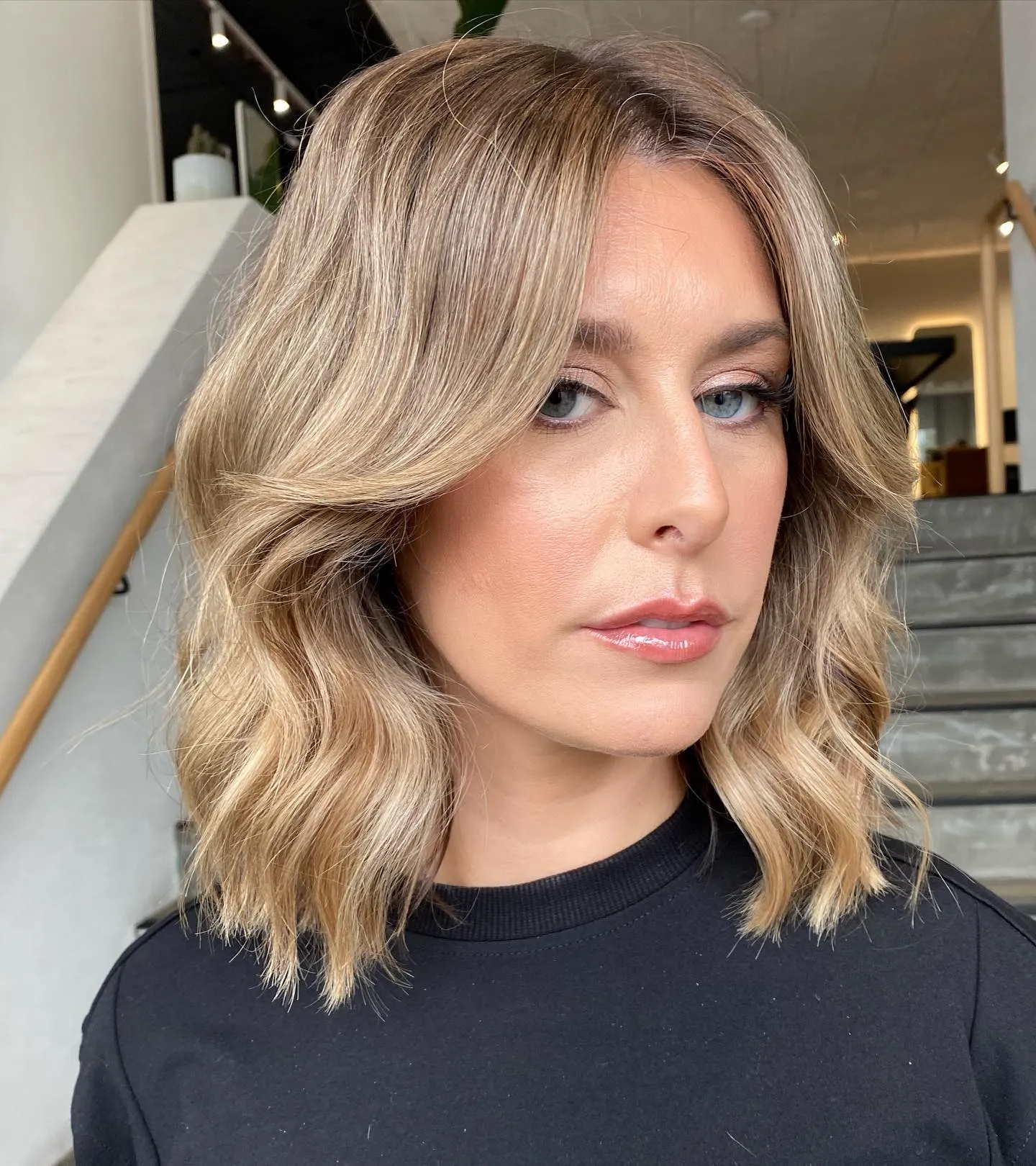 Soft wavy lob with sweeping curtain bangs and shoulder-skimming layers