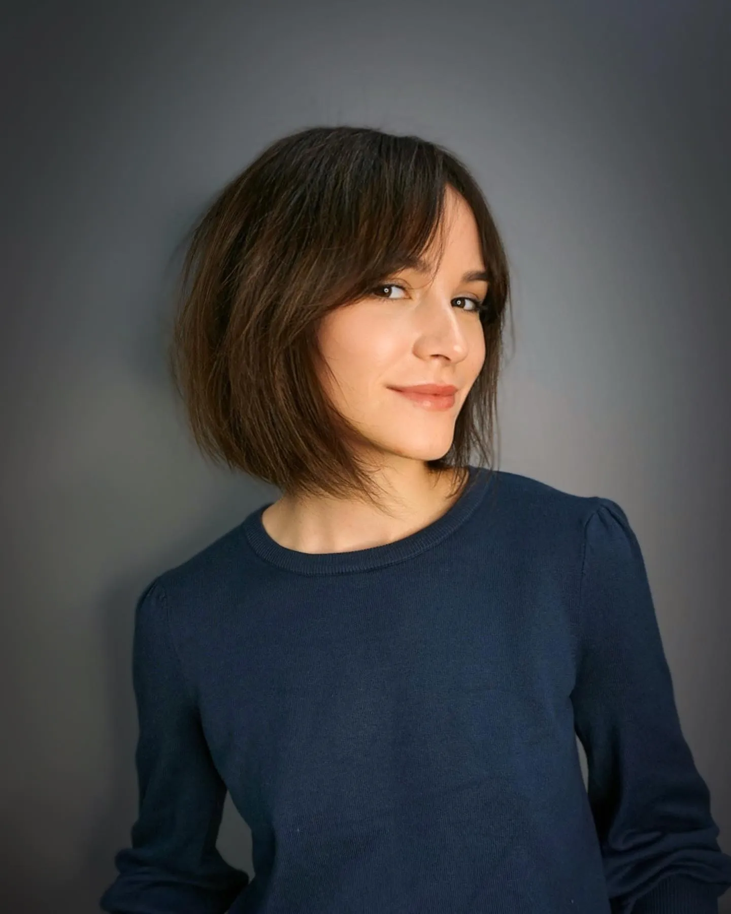 Sleek angled bob with curtain bangs and longer front pieces