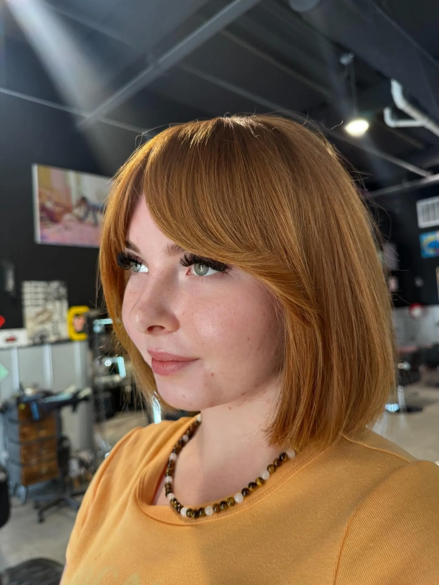Blunt short bob with long curtain bangs and smooth jaw-length ends