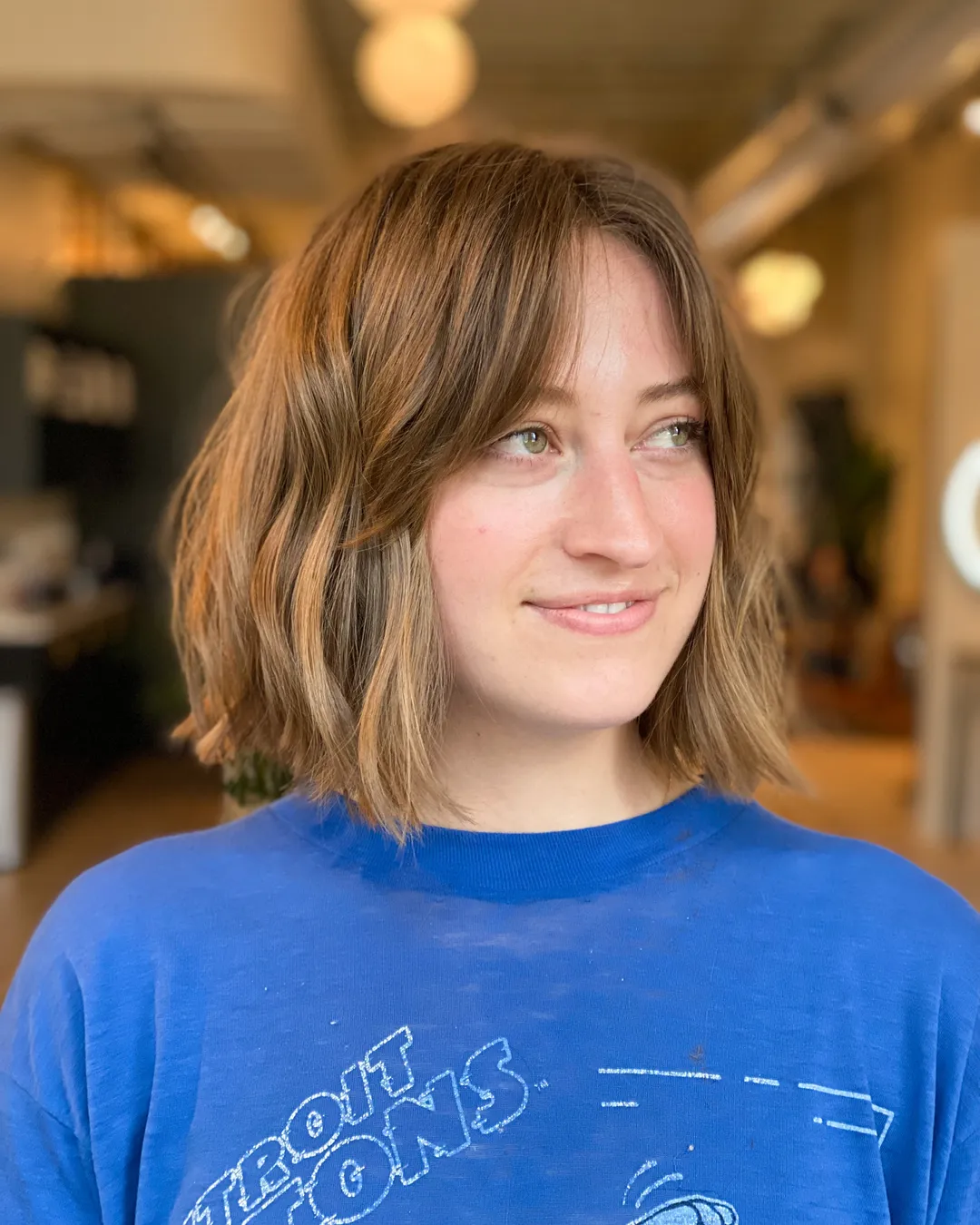 Textured short bob with soft curtain bangs and loose uneven waves