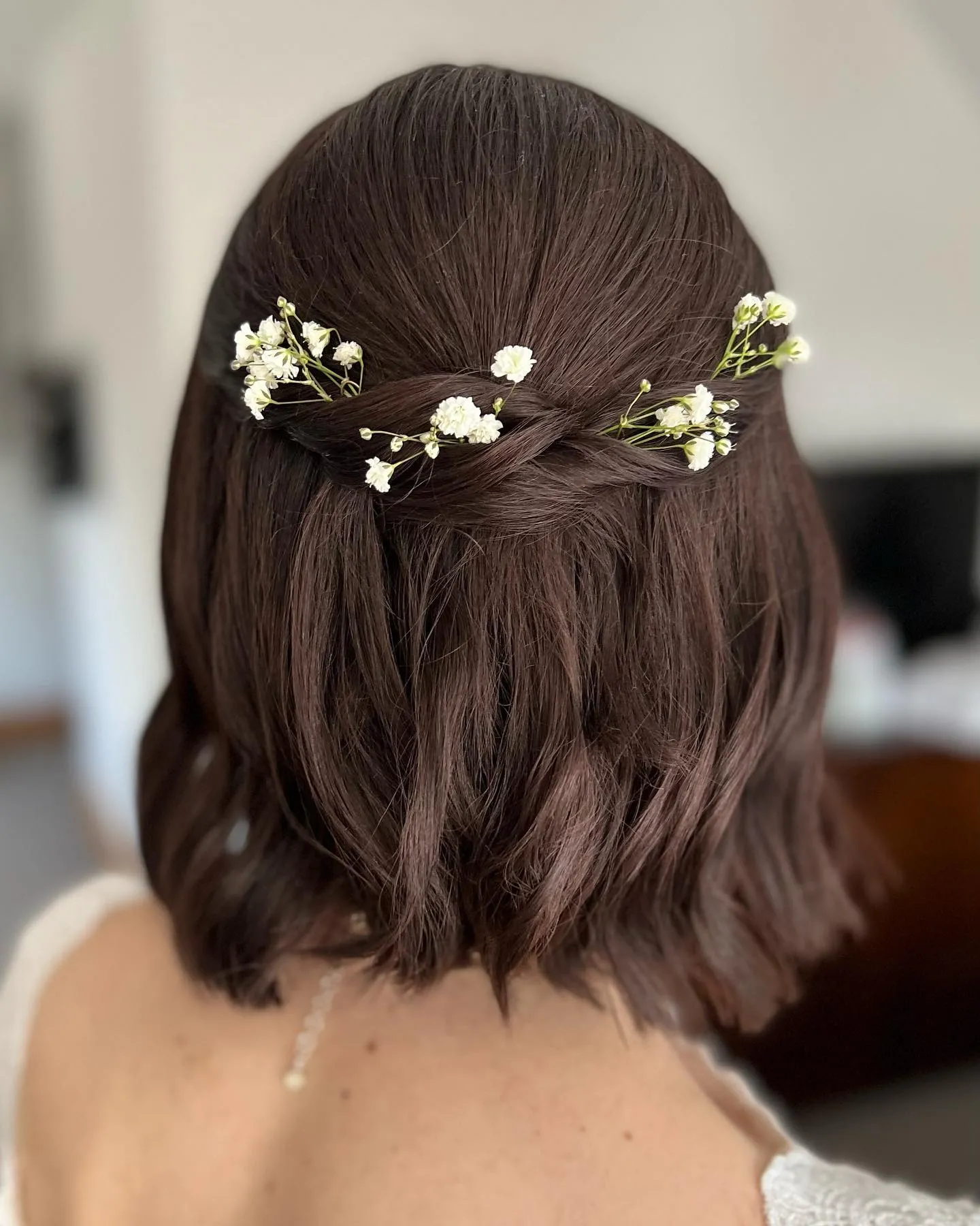 half-up wavy bridal bob with baby's breath
