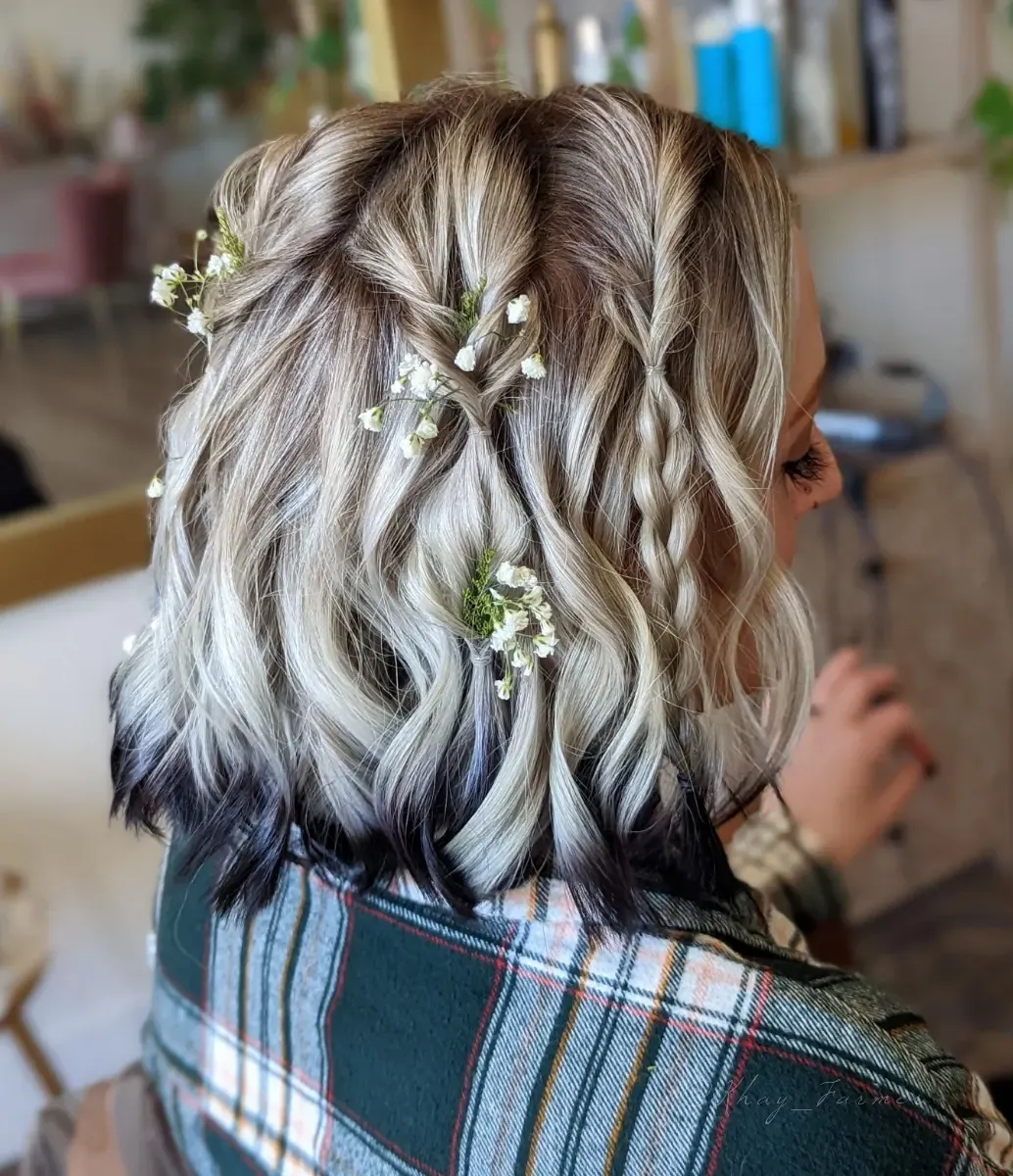icy blonde wavy bridal bob with tiny white flowers