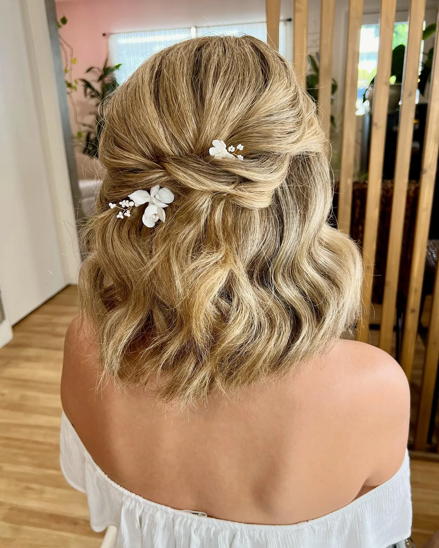 soft half-up blonde bridal bob with white floral pins