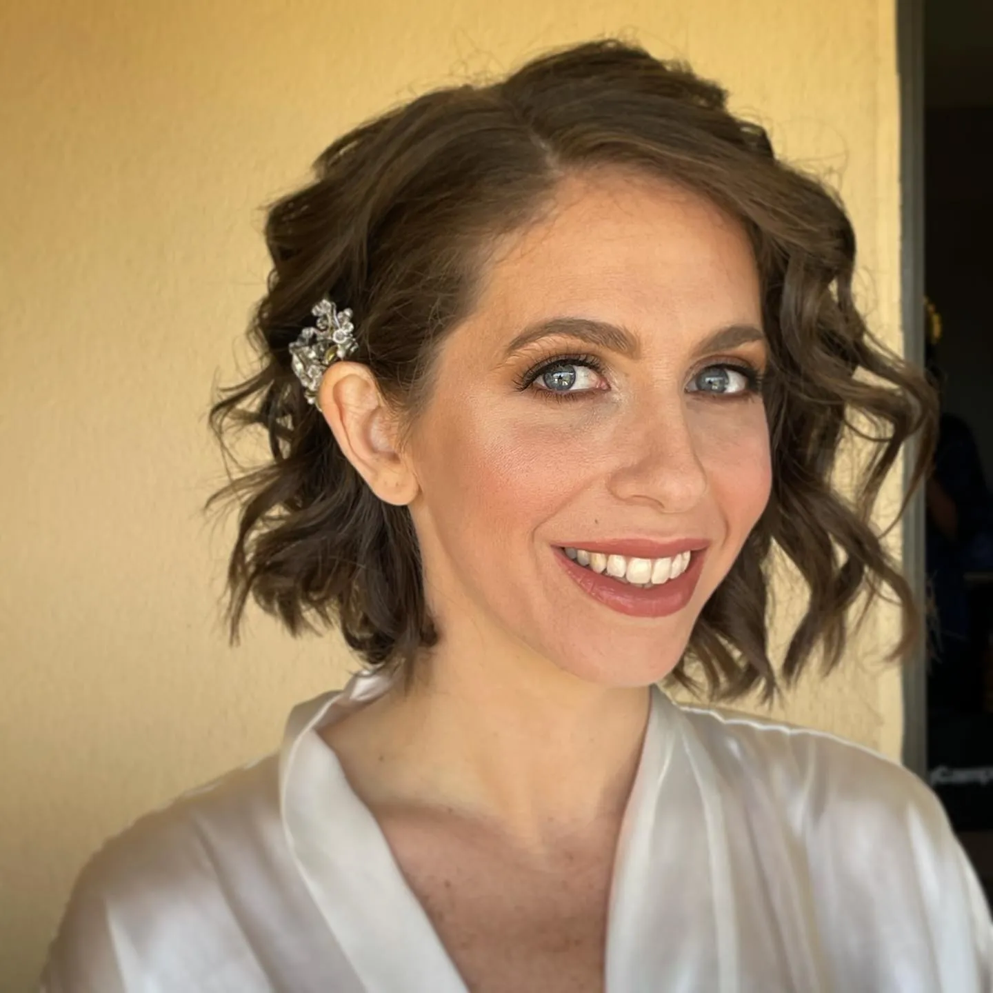 wavy short bridal bob with side twist and silver clip