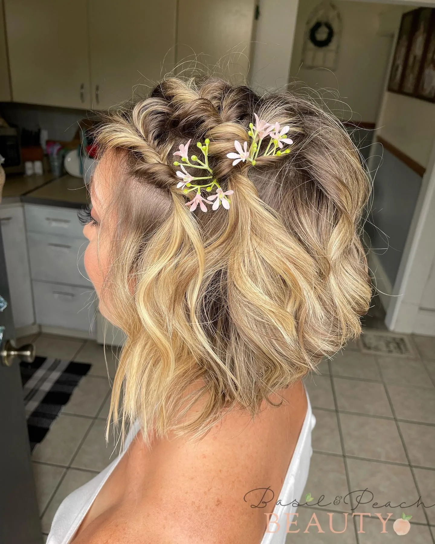 braided half-up bridal bob with pink floral sprig