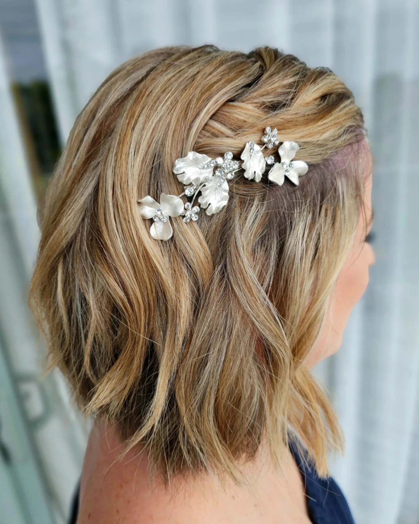 side-twisted short bridal bob with floral comb