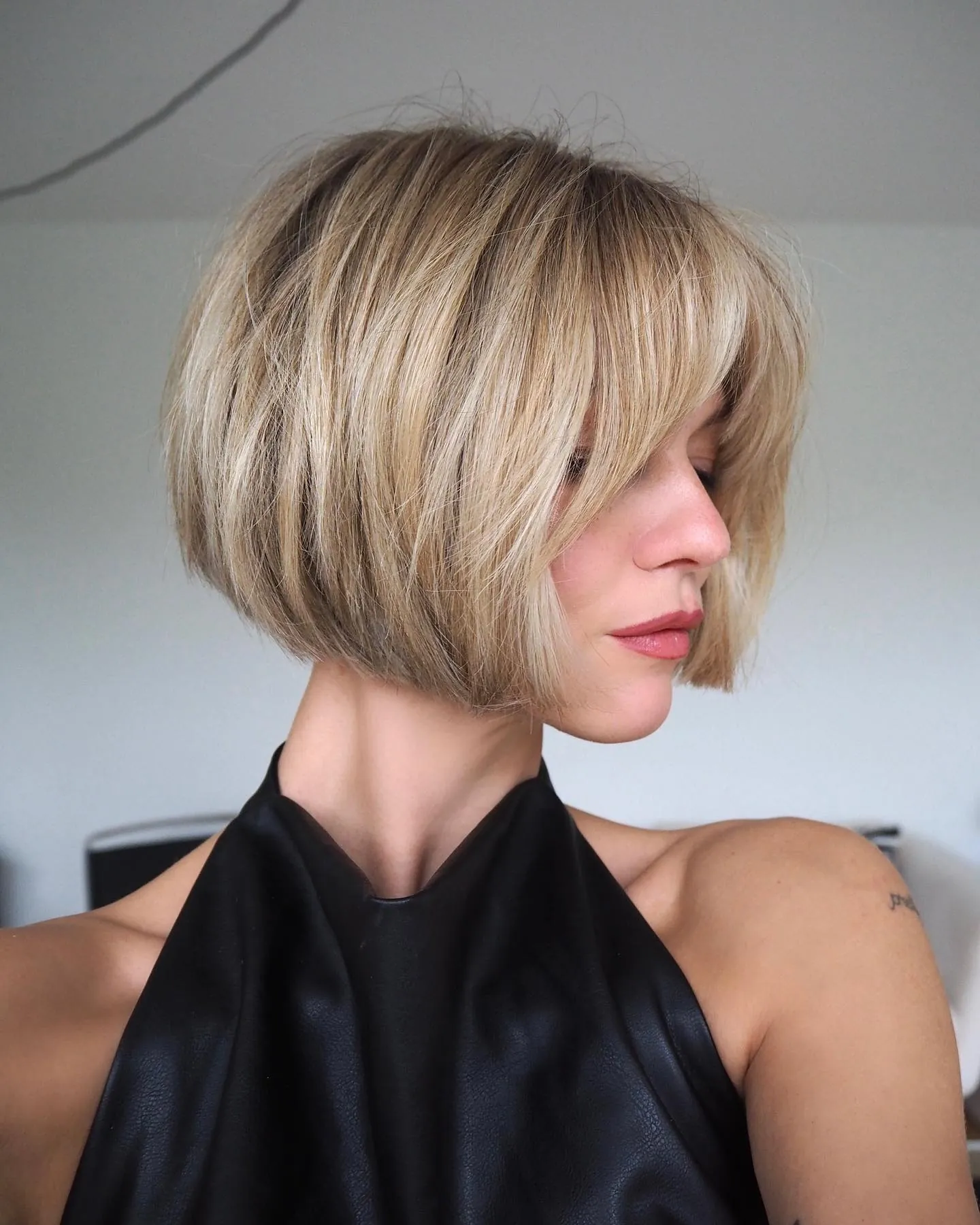 Rounded blonde bob with side-swept fringe