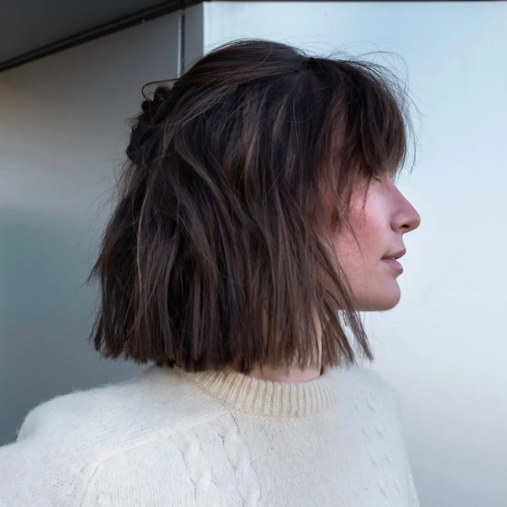 Half-up shaggy dark bob with choppy ends