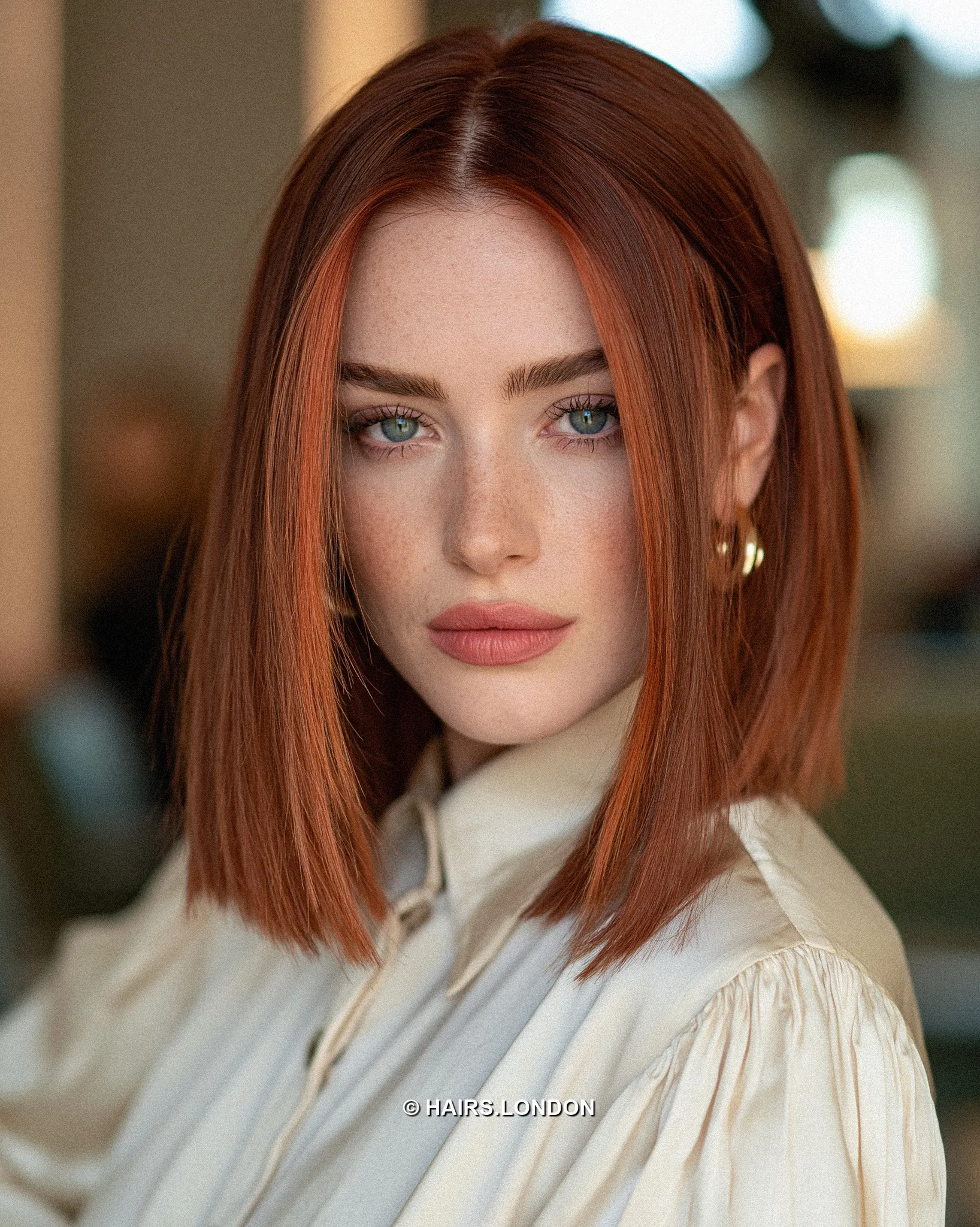 Sleek straight red lob with center part