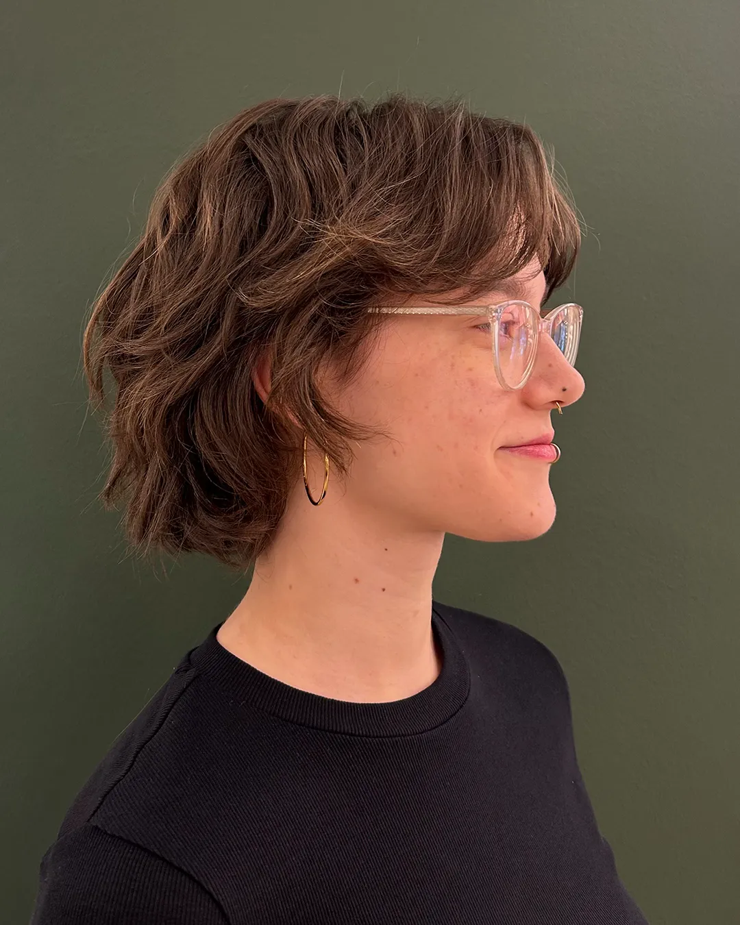 Short wavy shag with soft fringe and translucent pink glasses