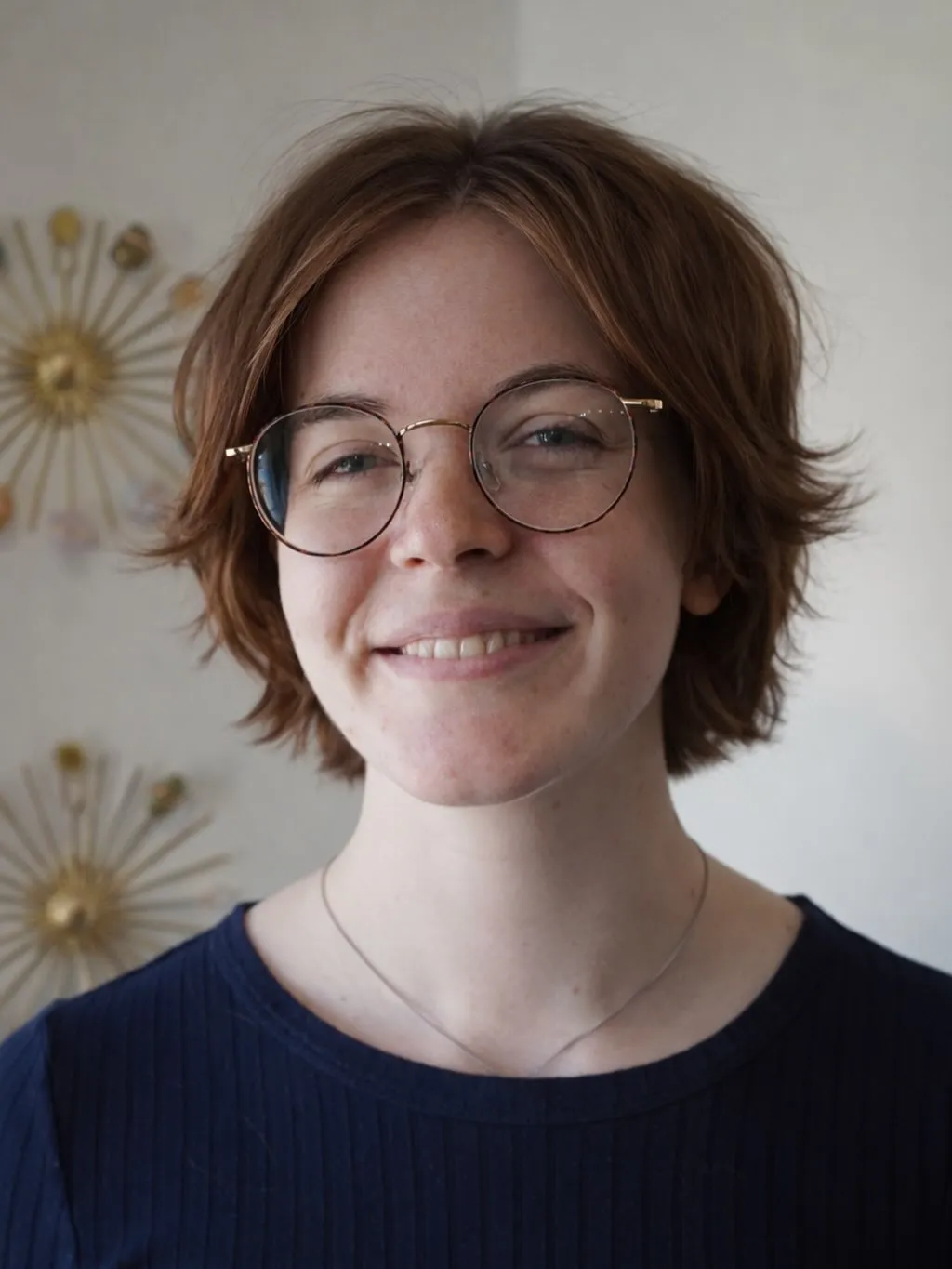 Soft brown layered crop with flipped ends and round glasses