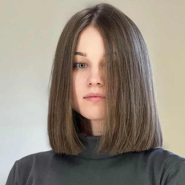 Sleek dark blunt lob with a center part