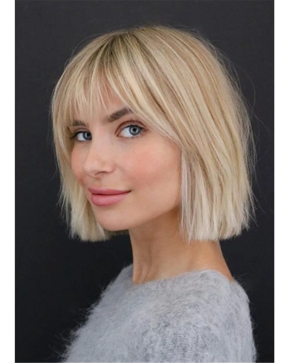 Blonde short bob with airy bangs and choppy ends