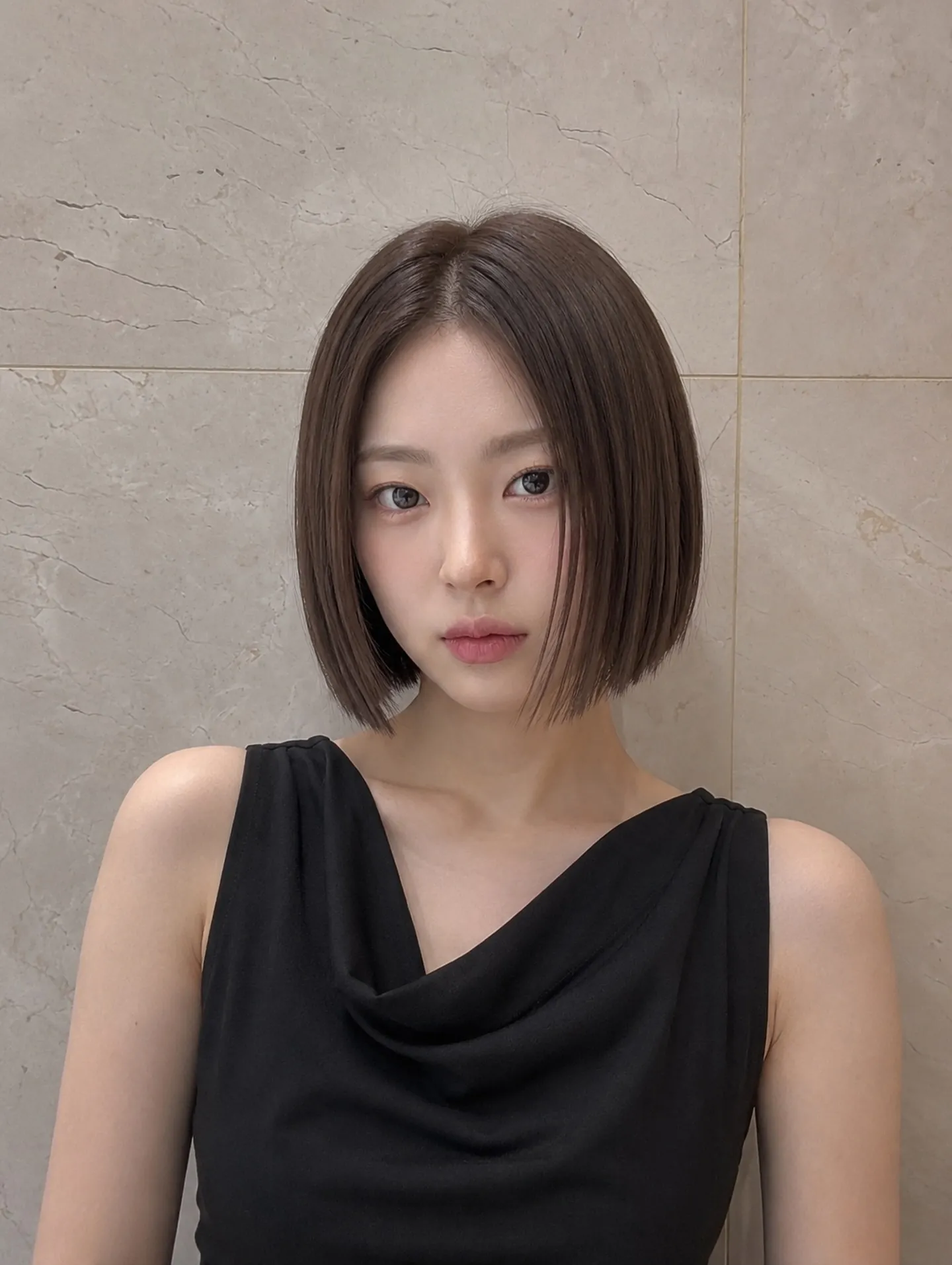 Dark chin-length straight bob with a center part