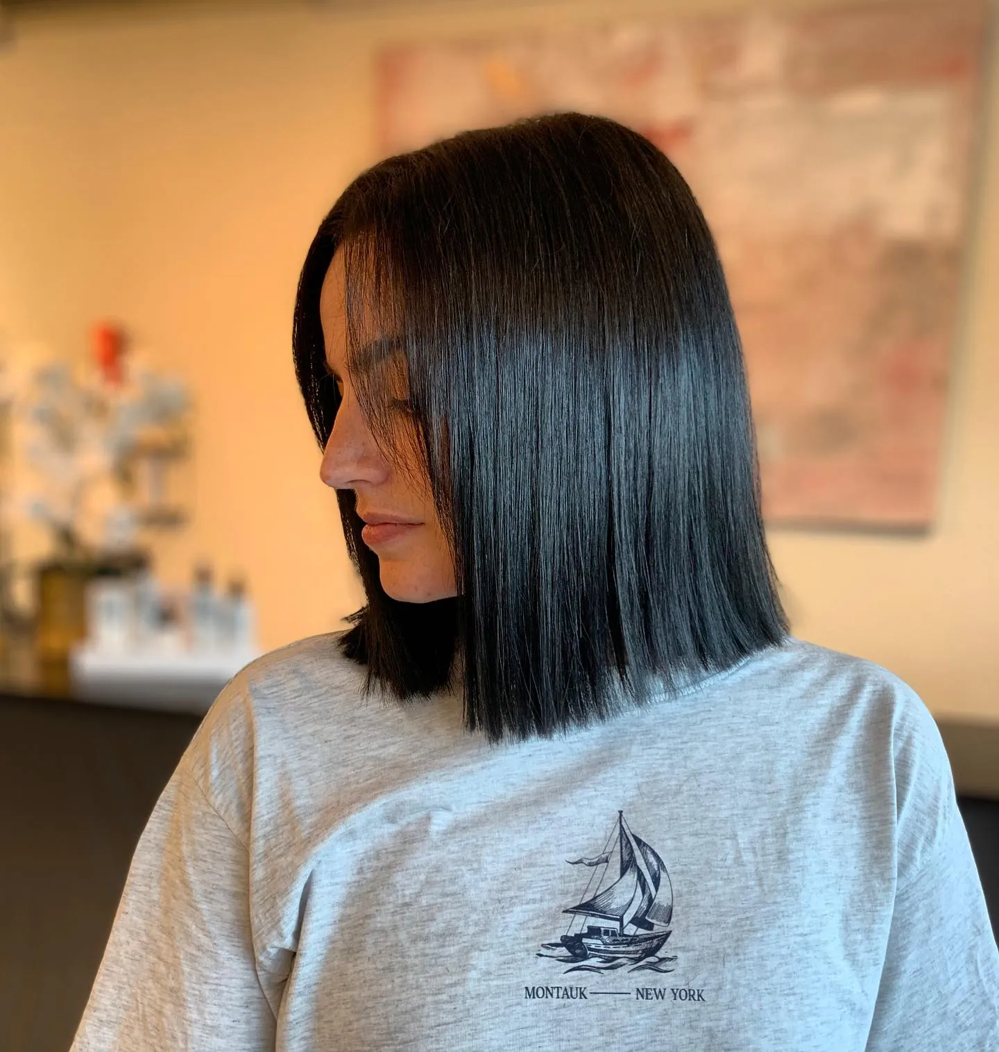 Glossy black blunt lob with a center part