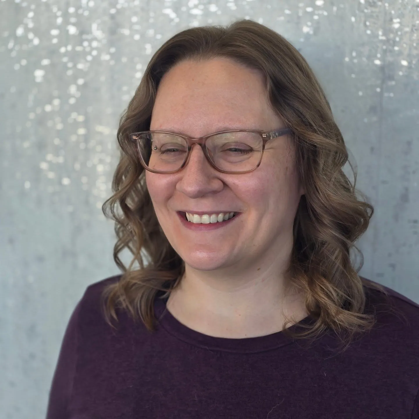 Shoulder-length lob styled with soft curls and a side part