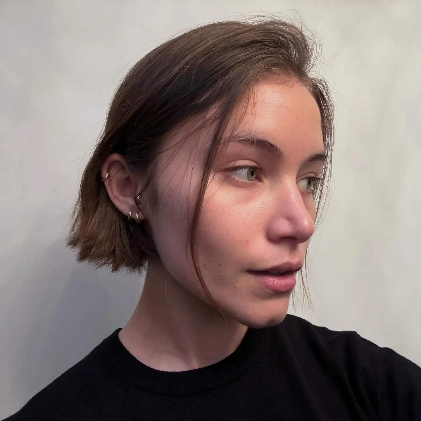 Short mini bob tucked behind the ears with loose front strands